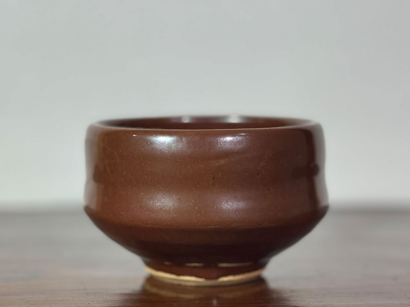 JAPANESE SOY GLAZED MONOCHROME CHAWAN: Japanese soy glazed porcelain chawan. Dimensions: Diameter: 4.5 in. (11.4 cm); Height: 3 in. (7.6 cm) Note: This item is in New York, where it can be shipped from.
