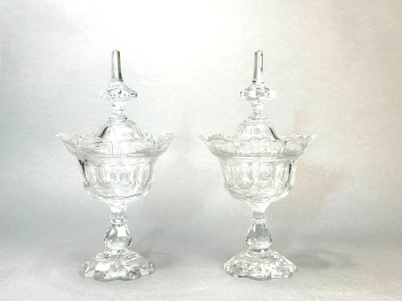 A PAIR OF IRISH CUT CRYSTAL COVERED VESSELS: A pair of Irish cut crystal covered vessels, 20th century, one with a tiny flake on the edge. Dimensions: Height: 12.5 in. (31.8 cm).