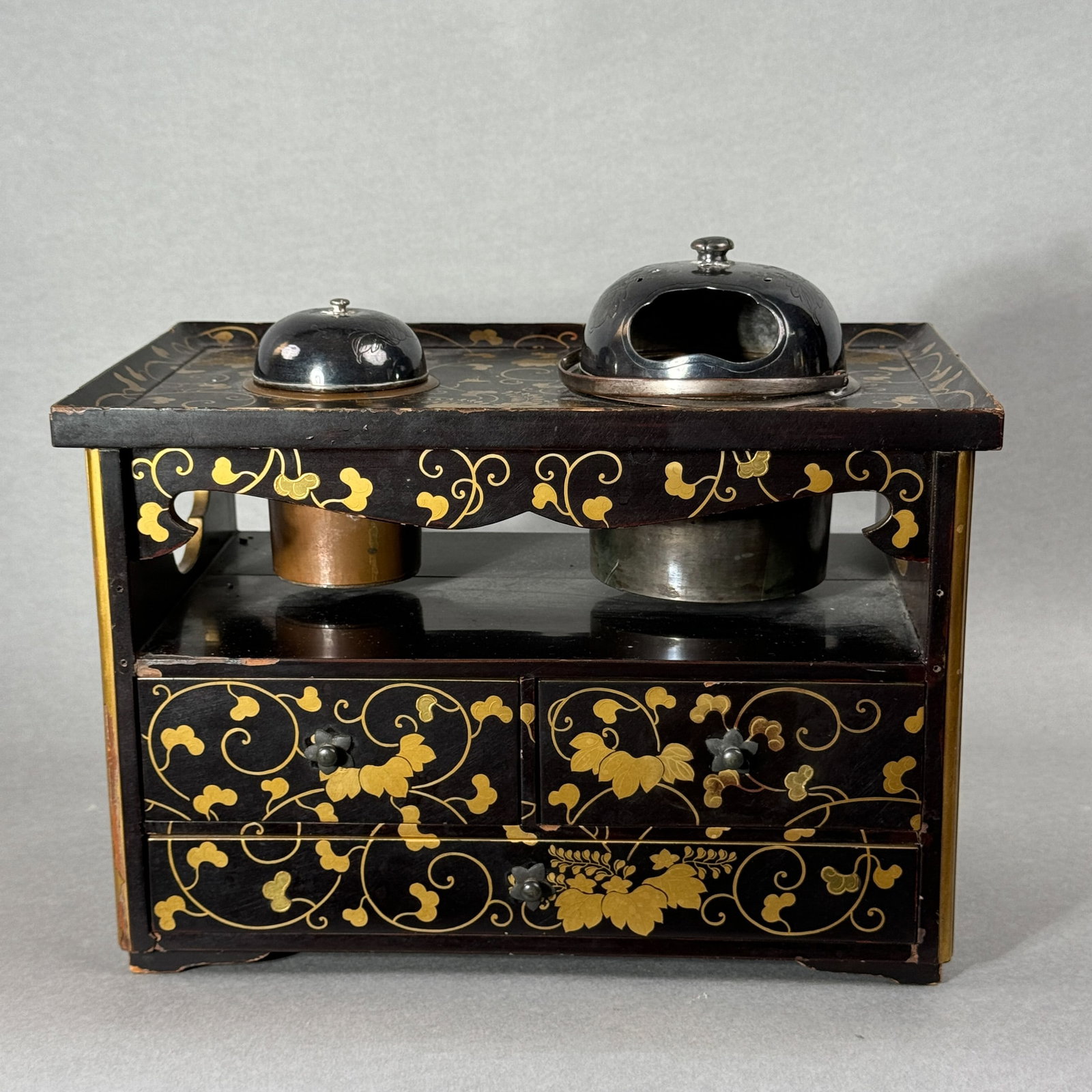 A JAPANESE EDO PERIOD LACQUER TOBACCO CHEST WITH SILVER COVER: A Japanese Edo period lacquer tobacco chest with a silver cover, Edo period, losses of wood and lacquer. Dimensions: 10.5 x 6.5 x 7 in. (26.7 x 16.5 x 17.8 cm).
