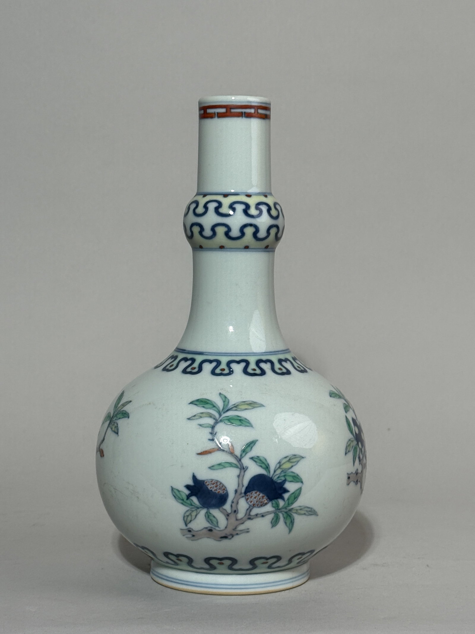 A CHINESE DOUCAI PORCELAIN VASE WITH FRUIT SCENE: A Chinese Doucai porcelain vase with a fruit scene. Dimensions: Height: 9.5 in. (24.1 cm).