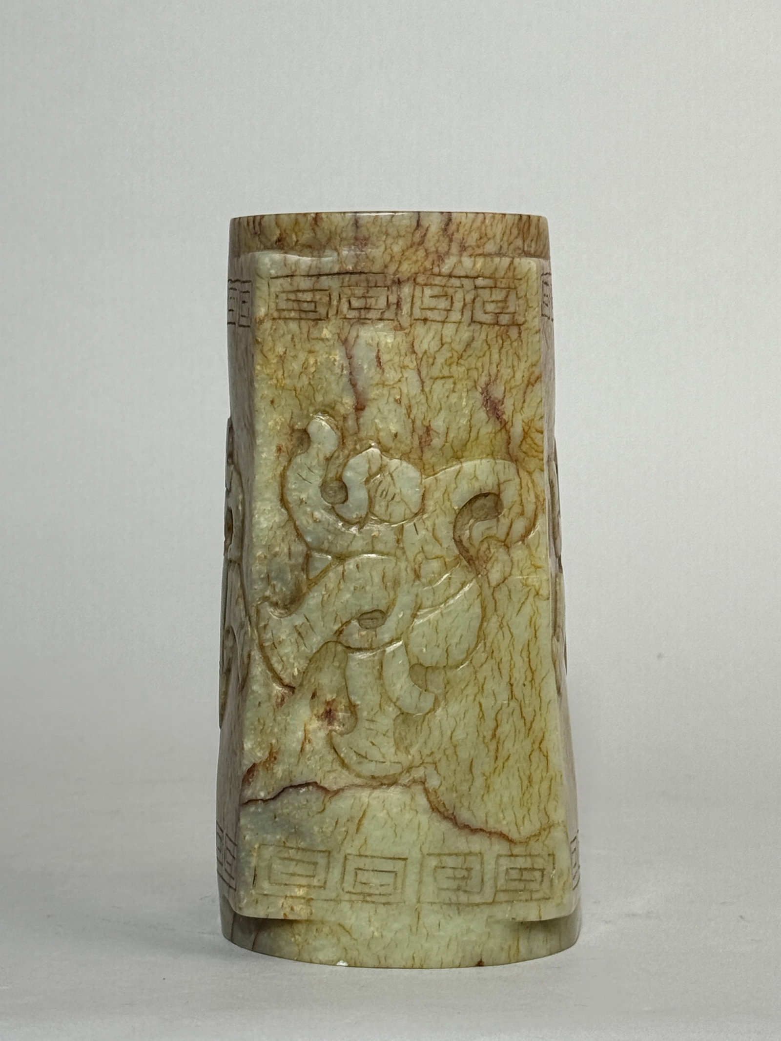 A CHINESE ARCHAIC JADE RITUAL VESSEL: A Chinese celadon jade ritual archaic vessel with a dancer. Dimensions: Height: 7 in. (17.8 cm).