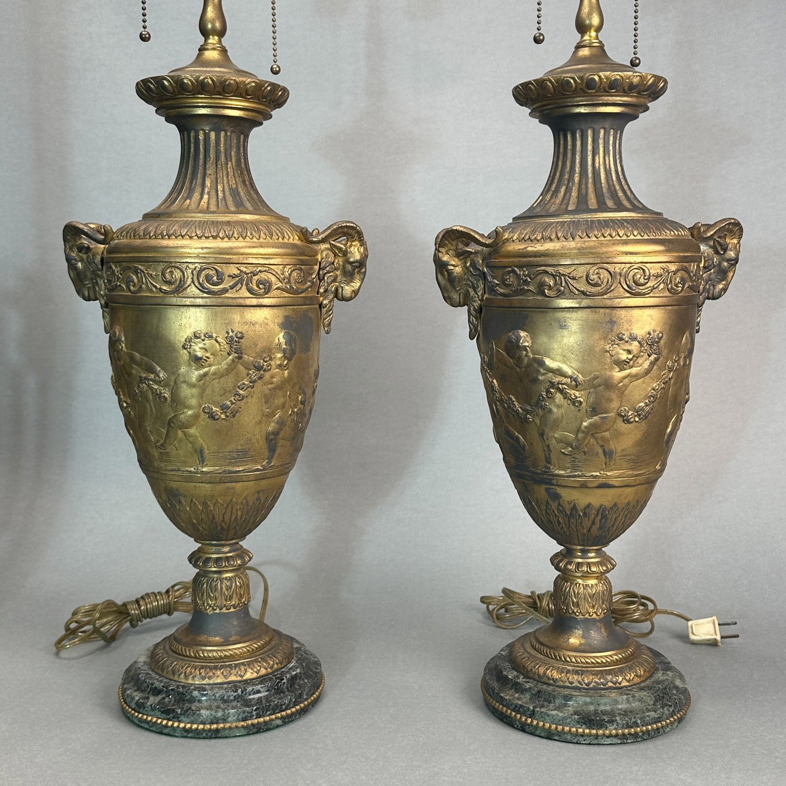 A PAIR OF FRENCH GRAND TOUR LAMPS WITH RAM'S HEADS: A pair of French Grand Tour lamps with ram's heads, 19th century. Dimensions: Urn height: 19 in. (48.3 cm); Overall height: 28 in. (71.1 cm).