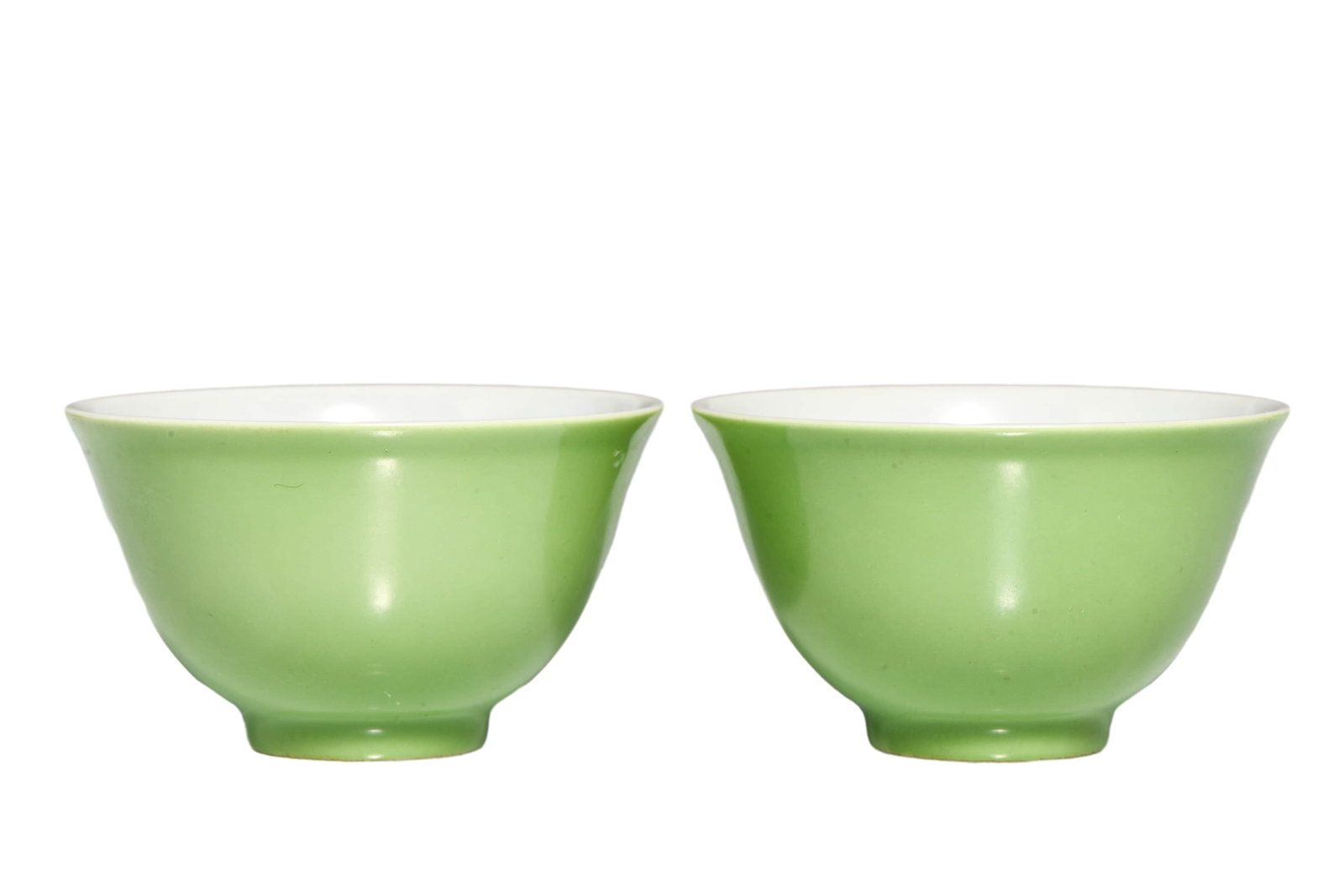 PAIR OF GREEN-GLAZED CUPS: A pair of green-glazed cups. Dimensions: 7.5 x 4 cm. All measurements are approximate.