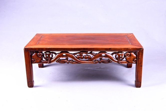 A Huanghuali wood tea table: Small Carved Huanghuali Table. Height 11" Width 16.25" Length 30" 黄花梨雕刻茶桌