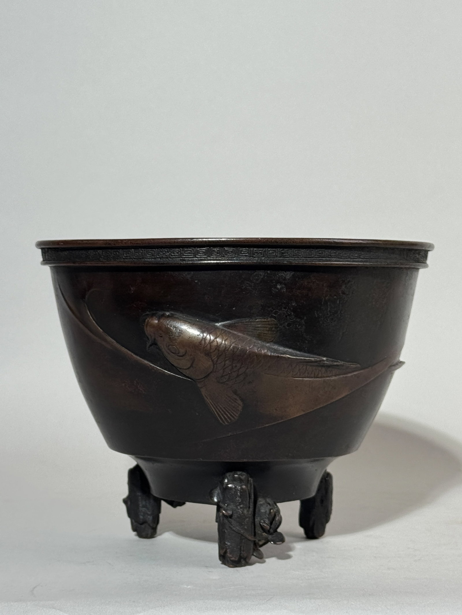 A JAPANESE MEIJI BRONZE CENSER WITH MORIAGE KOI: A Japanese Meiji bronze bowl or censer with a moriage koi design, signed at the bottom. Dimensions: Diameter: 7.5 in. (19.1 cm); Height: 5.75 in. (14.6 cm). Note: This item is in New York, where it ca