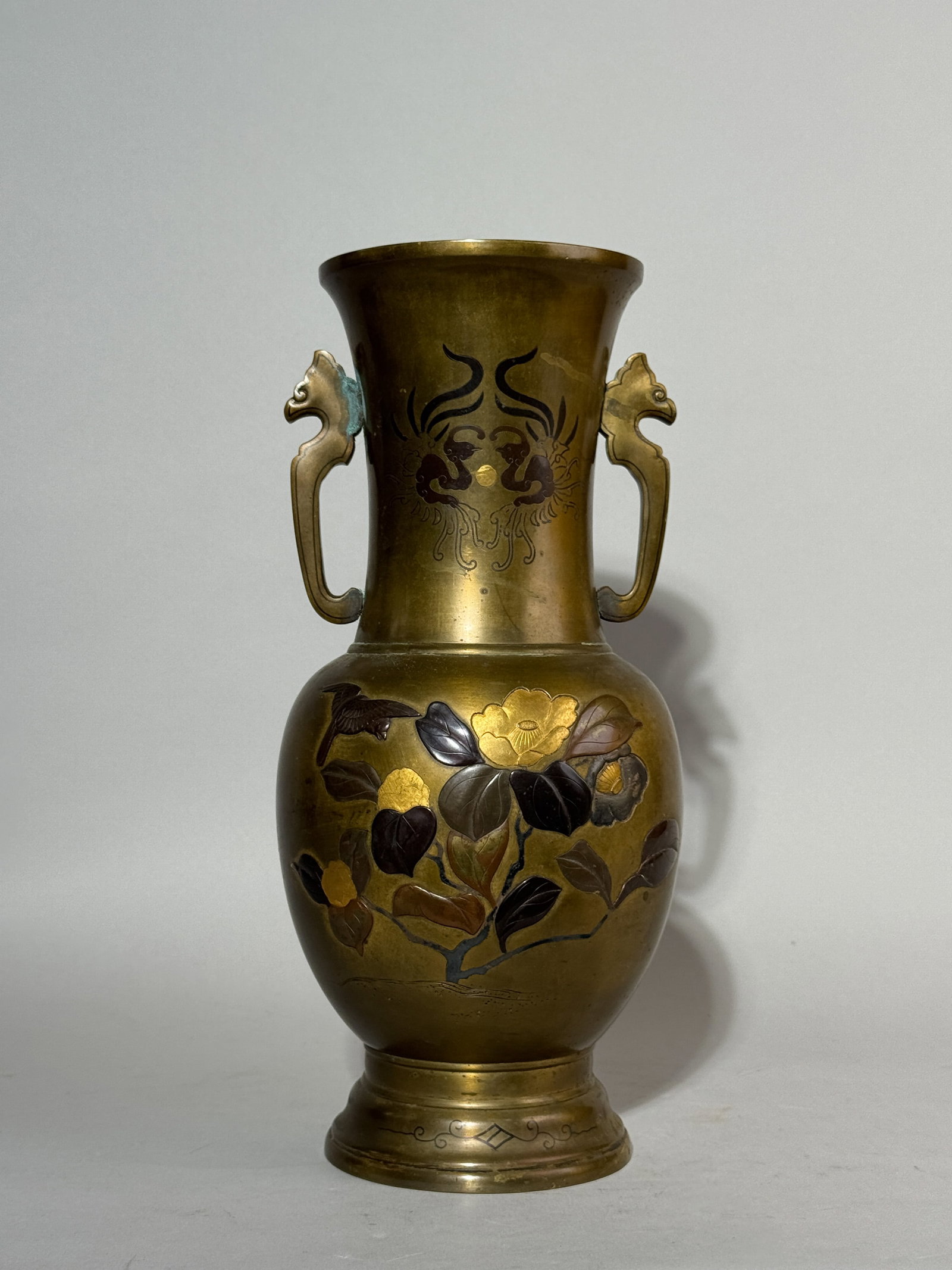 A JAPANESE MIXED METAL VASE WITH FLORAL BIRD: A Japanese Meiji mixed metal bronze vase decorated with a floral bird scene, previously drilled for a lamp. Shallow dent on the side. Dimensions: Height: 12.25 in. (31.1 cm). Note: This item is in New