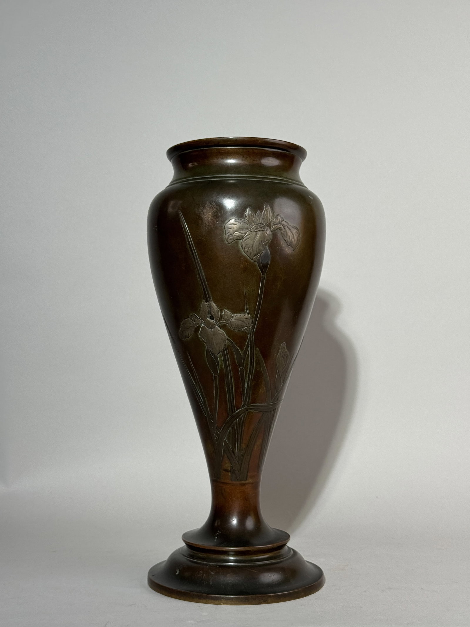 A JAPANESE MIXED METAL VASE WITH IRIS DESIGN: A Japanese mixed metal vase with an iris design, signed. Shallow dent on the shoulder. Dimensions: Height: 15 in. (38.1 cm). Note: This item is in New York, where it can be shipped from.