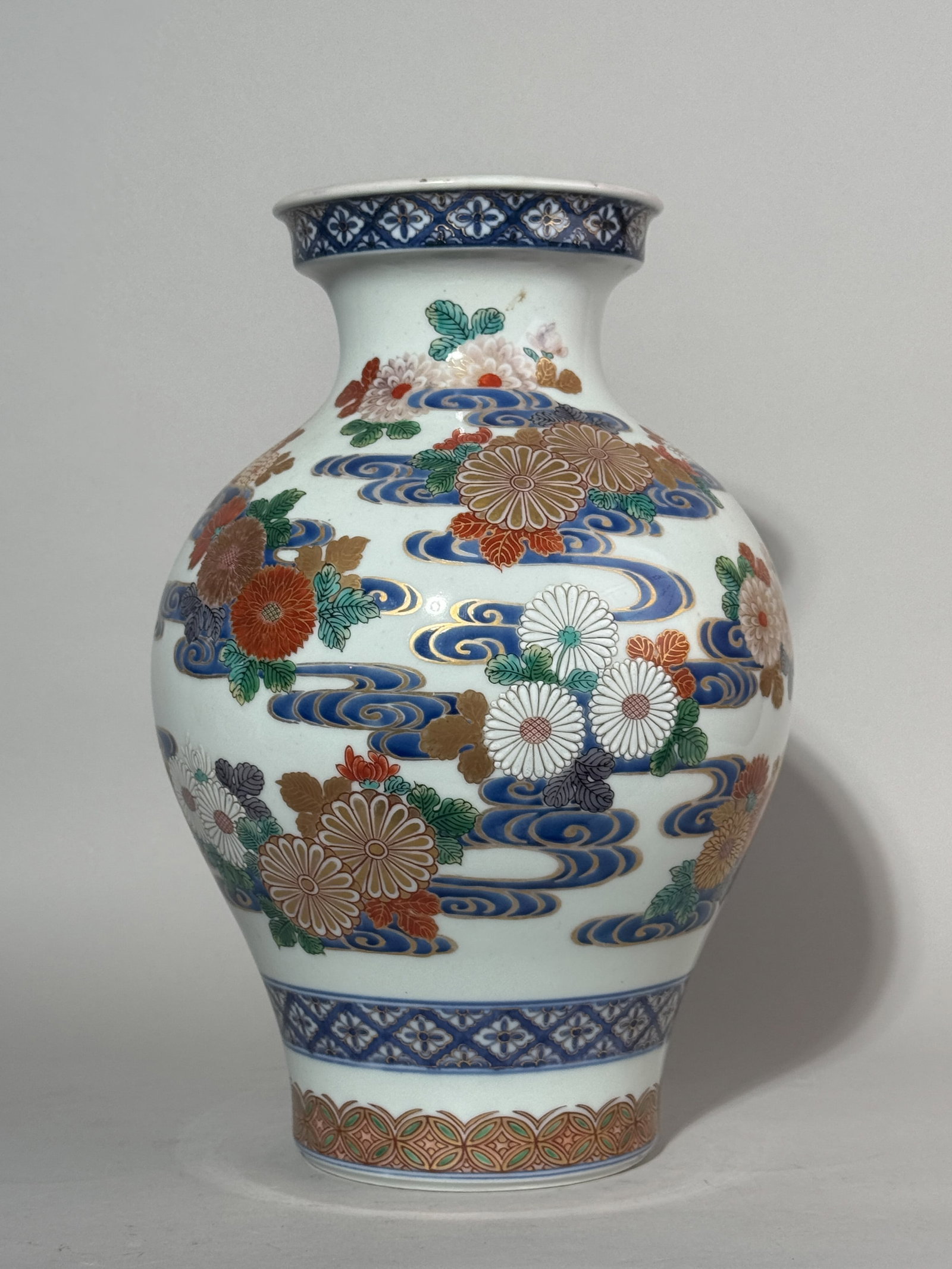 A JAPANESE STUDIO PORCELAIN VASE WITH CHRYSANTHEMUM: A Japanese Meiji studio porcelain vase with a chrysanthemum motif, bottom with a Fuku mark. Dimensions: Height: 13.25 in. (33.7 cm). Note: This item is in New York, where it can be shipped from.
