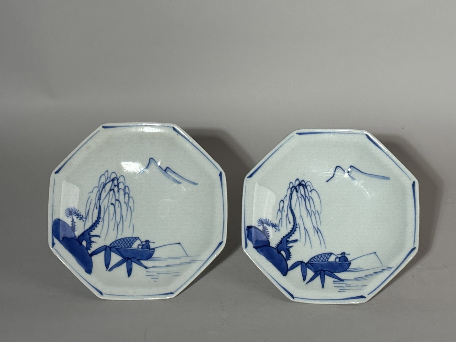 A PAIR OF JAPANESE ARITA PORCELAIN DISHES WITH FISHERMAN: A pair of Japanese blue and white Arita porcelain dishes with fisherman motifs. Dimensions: Width: 7 in. (17.8 cm). Note: This item is in New York, where it can be shipped from.