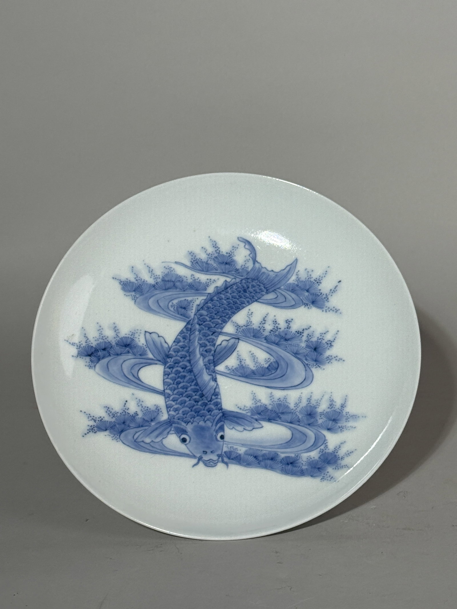 A JAPANESE BLUE AND WHITE HIRADO PORCELAIN DISH WITH KOI: A Japanese blue and white Hirado porcelain dish with a koi motif. Dimensions: Diameter: 7.2 in. (18.3 cm). Note: This item is in New York, where it can be shipped from.