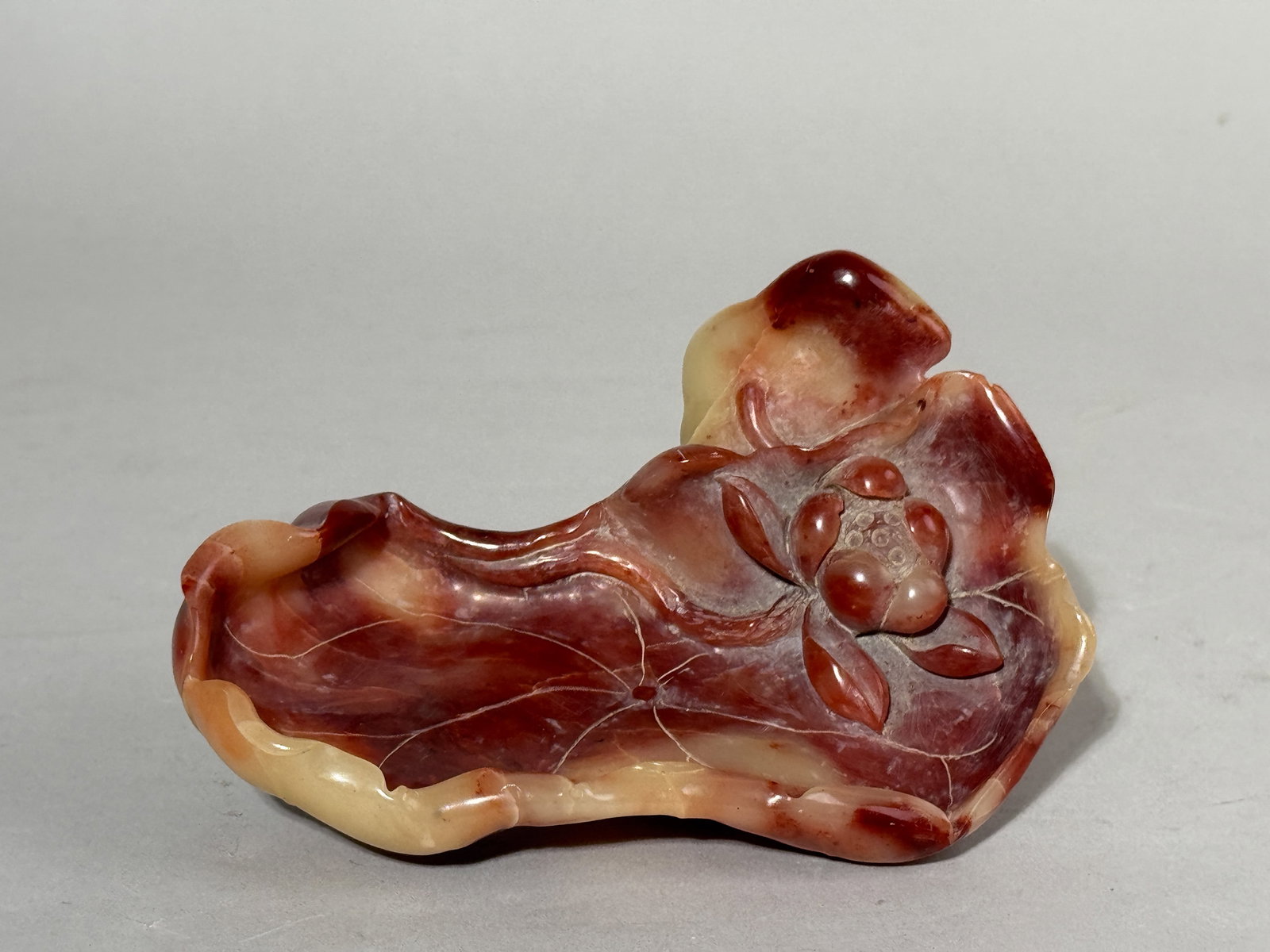A CHINESE SHOUSHAN STONE SCHOLAR BRUSH WASHER: A Chinese Shoushan stone carved scholar brush washer of lotus form. Dimensions: Length: 5.5 in. (14 cm). Note: This item is in New York, where it can be shipped from.