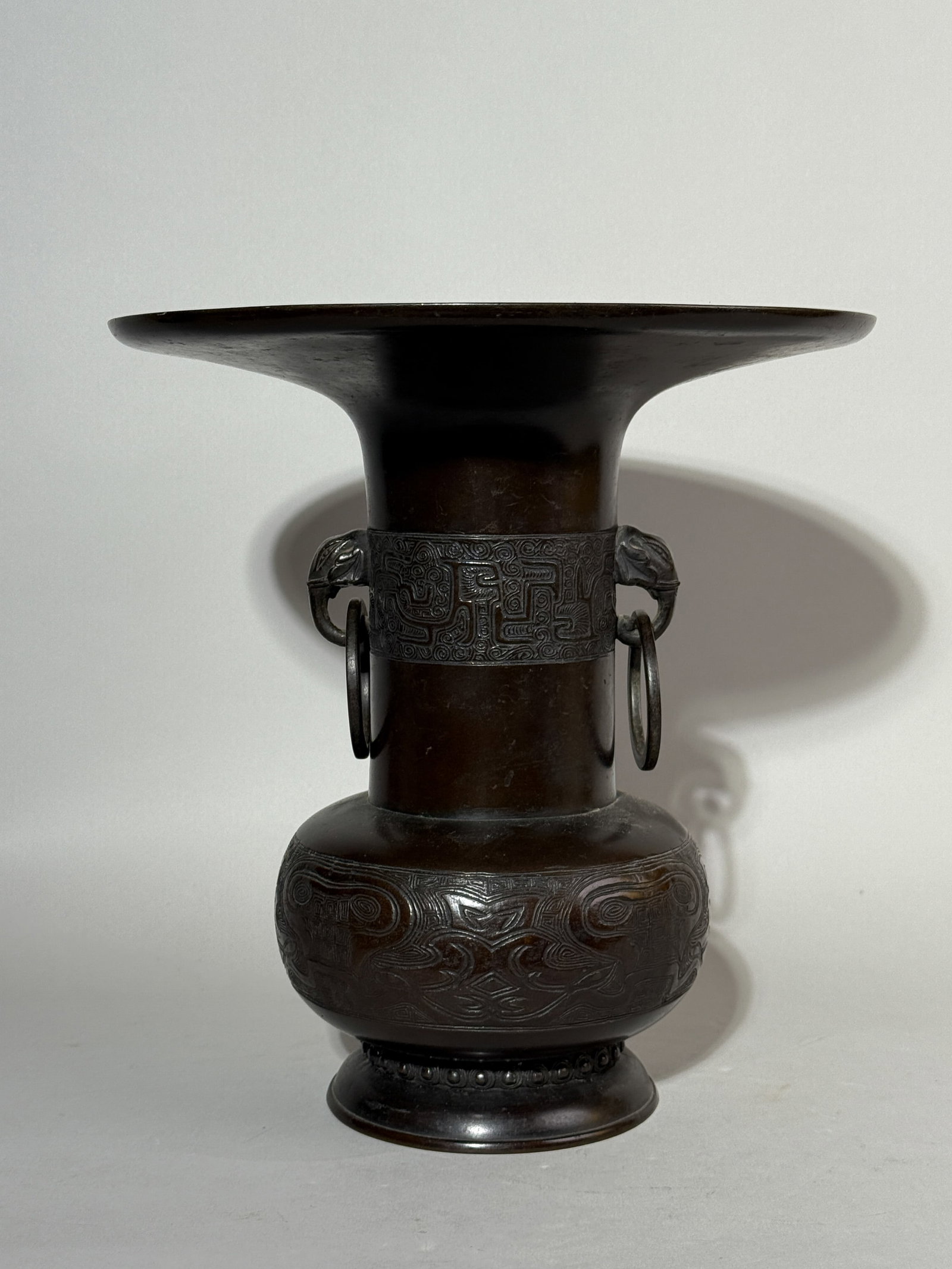 JAPANESE BRONZE VASE WITH FLARED OUT TOP RIM: A Japanese Meiji period bronze vase with a wide flared out top rim and elephant ear handles. Dimensions: Height: 11.25 in. (28.6 cm); Diameter: 11 in. (27.9 cm). Note: This item is in New York, where