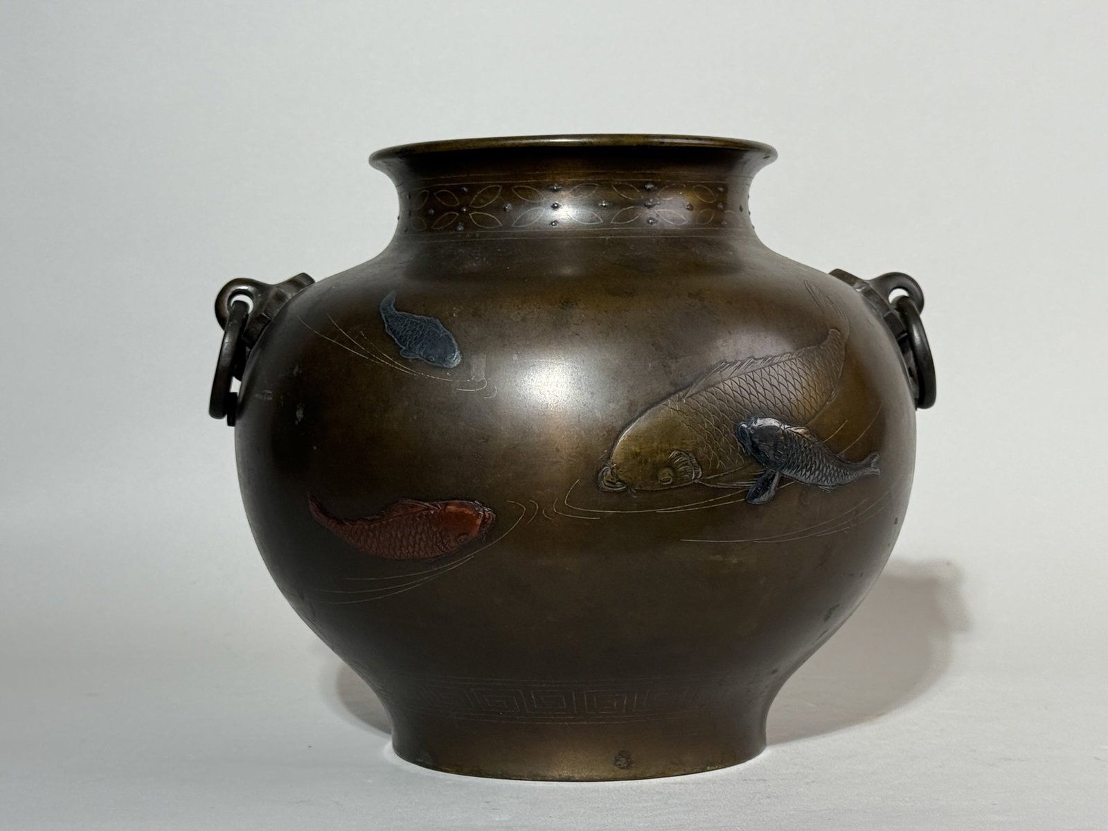 JAPANESE MIXED METAL BRONZE VASE WITH KOI: A Japanese Meiji period bronze mixed metal vase with silver beads and koi inlay. Dimensions: Width: 10.5 in. (26.7 cm); Height: 7.5 in. (19.1 cm). Note: This item is in New York, where it can be