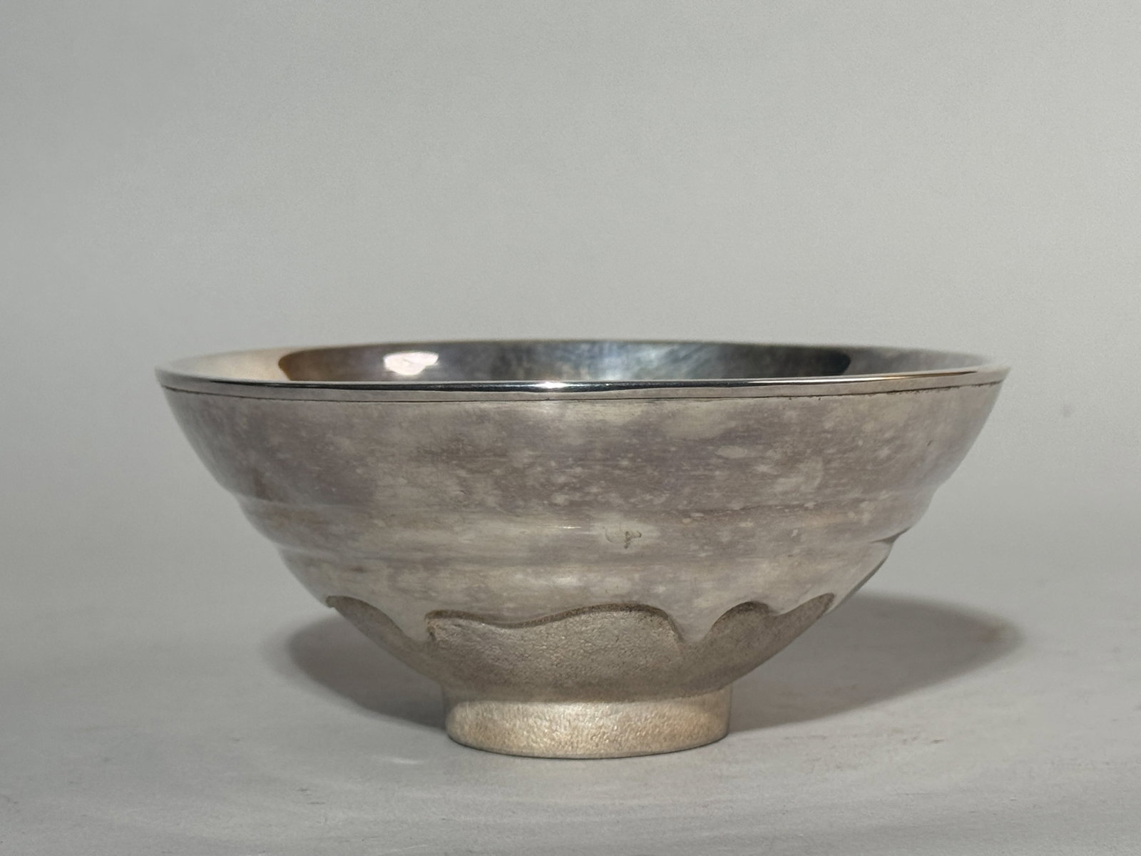 JAPANESE STERLING SILVER CHAWAN: A Japanese sterling silver chawan with a maker's stamp at the bottom. Weighs 185 grams (5.95 ozt). Dimensions: Diameter: 5.3 in. (13.5 cm); Height: 2.5 in. (6.4 cm). Note: This item is in New York, wh
