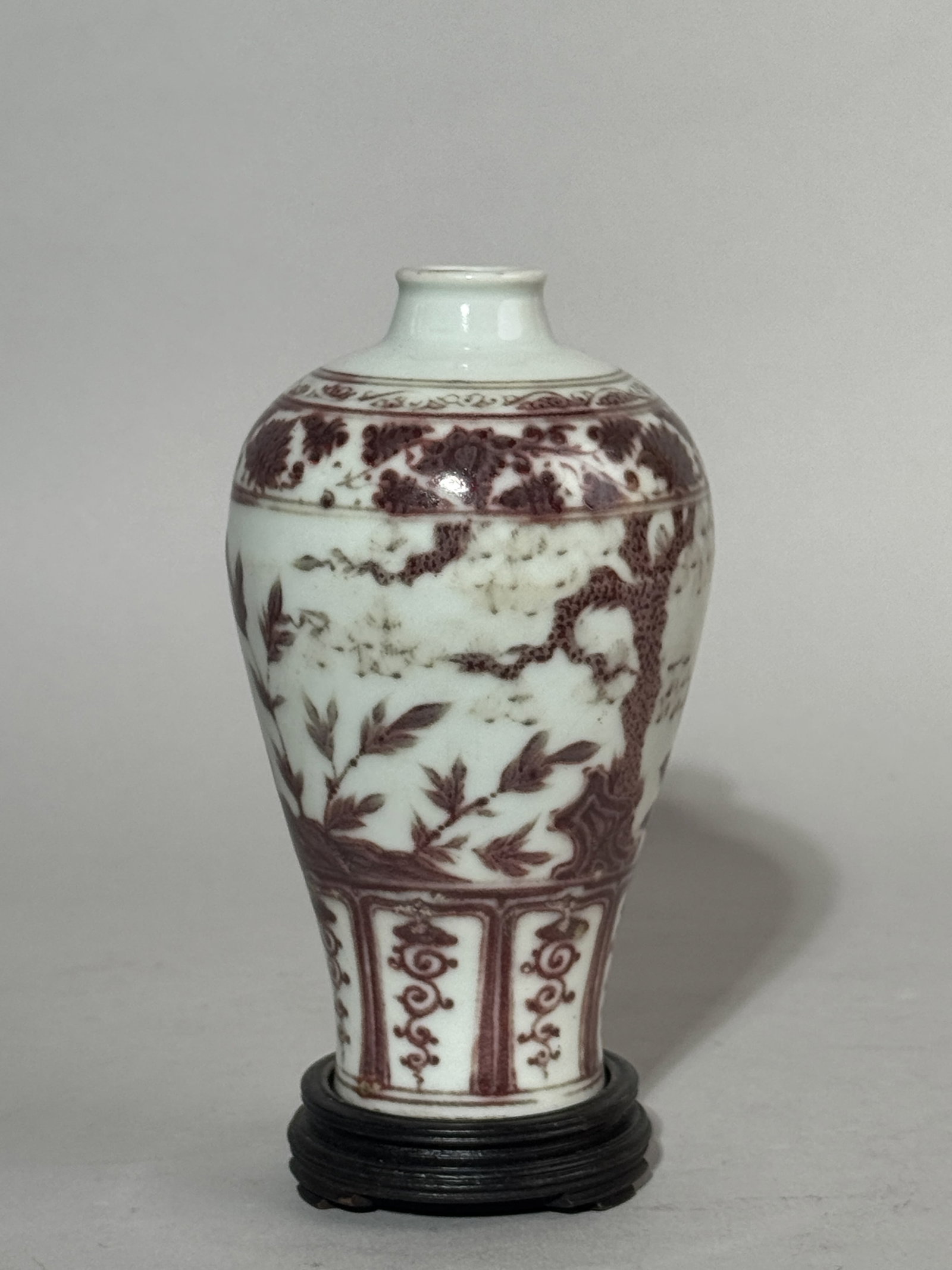 CHINESE MEIPING WITH COPPER-RED PLUM BLOSSOM SCENE: A Chinese copper-red decorated Meiping with a pine and plum blossom scene, on a hardwood base. Dimensions: Vase height: 5.5 in. (14 cm). Note: This item is in New York, where it can be shipped from.