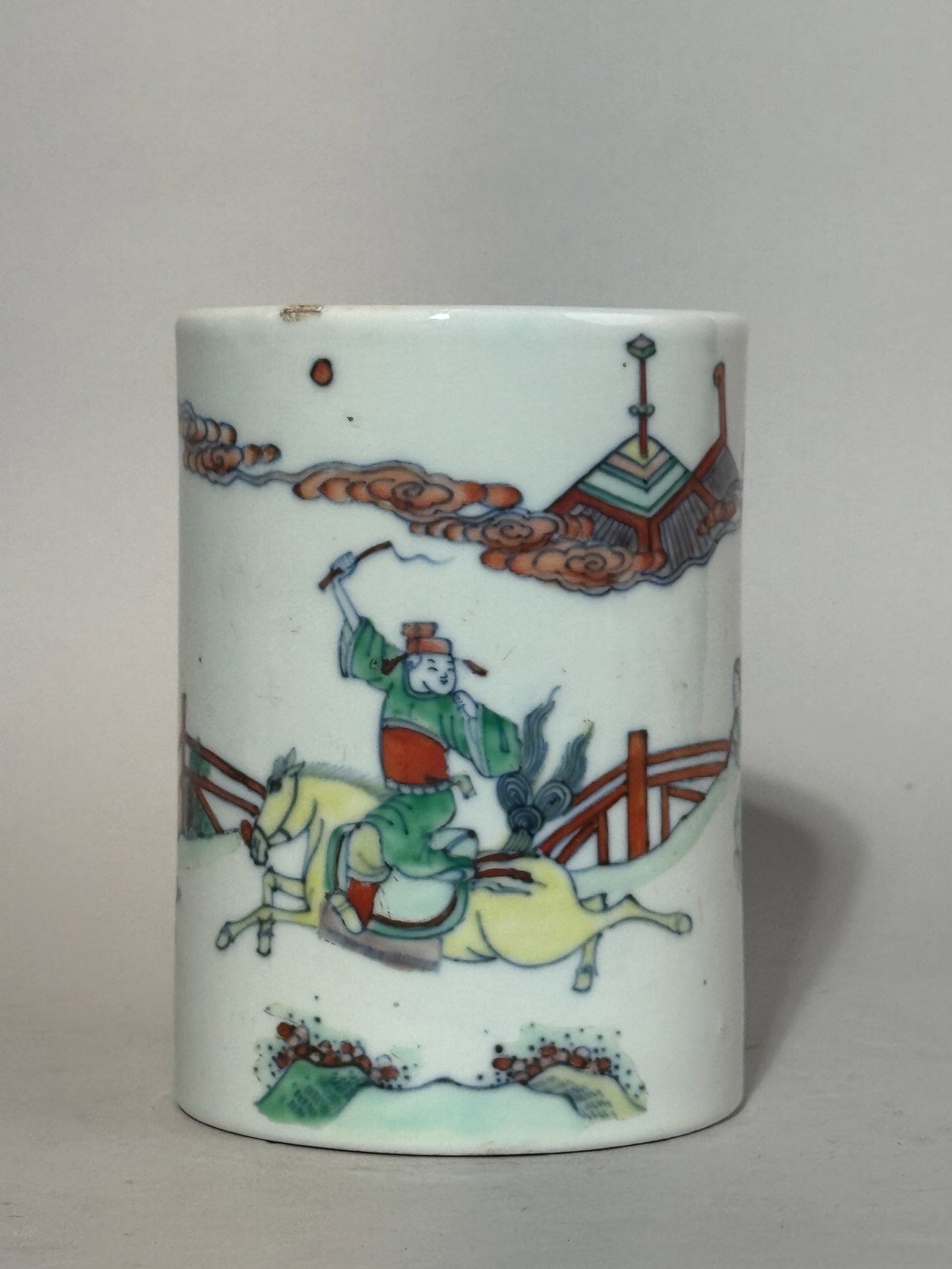 CHINESE SCHOLAR PORCELAIN BRUSHPOT WITH FIGURAL SCENE: A Chinese scholar porcelain brushpot with a Doucai glaze and a figural scene. Small fritting and glaze peeling off at the top rim. Dimensions: Height: 5.25 in. (13.3 cm); Diameter: 4 in. (10.2 cm). No