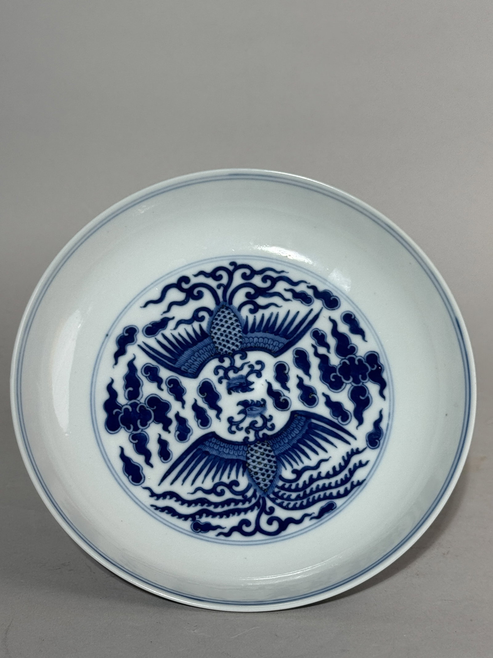 CHINESE BLUE AND WHITE PORCELAIN DISH WITH PHOENIX: A Chinese blue and white porcelain dish with a phoenix motif. Dimensions: Diameter: 6.75 in. (17.1 cm). Note: This item is in New York, where it can be shipped from.