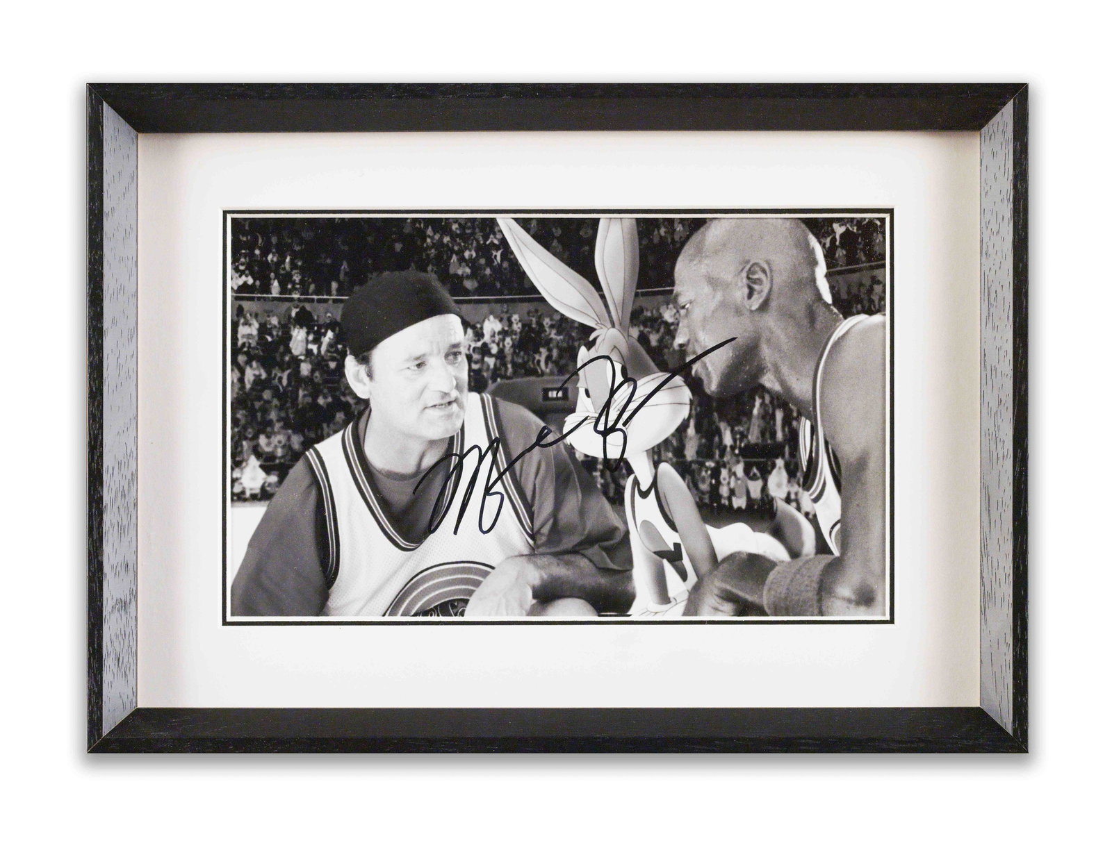 MICHAEL JORDAN, PHOTOGRAPH "SPACE JAM", BEARING SIGNATURE: A black and white photograph depicting Michael Jordan with Bill Murray and Bugs Bunny on a basketball court. The photograph bears an ink mark in the name of Michael Jordan.