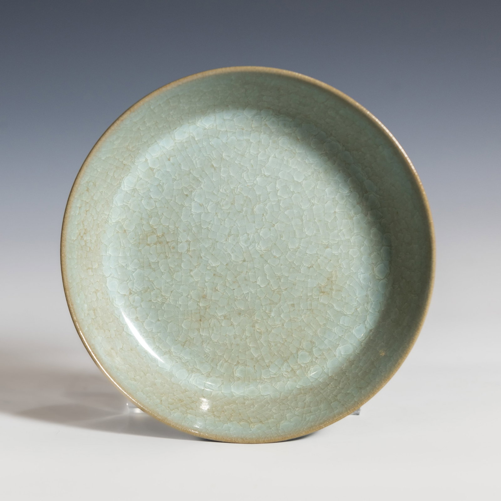 Chinese Celadon-Glazed Dish: Chinese celadon-glazed dish with shallow rounded sides rising to a slightly everted rim, covered overall in a translucent glaze suffused with a dense network of ice-crackle patterns. 1.57"h x 5.71"d