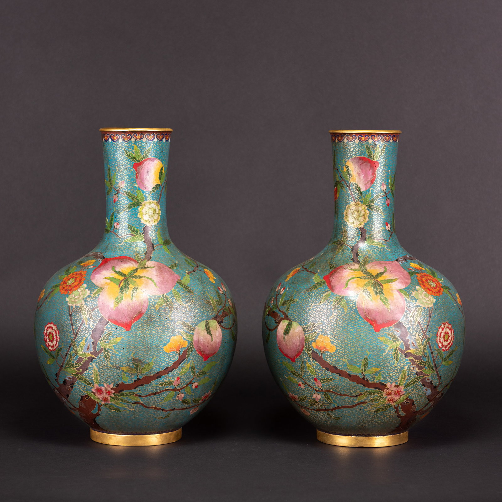 Pair of Chinese Cloisonne Enamel Nine Peach Vases, 19th Century: (lot of 2) Pair of Chinese cloisonne enamel "nine peach" vases. With a globular body and slender neck, decorated with the spreading branches of a fruiting peach tree bearing nine peaches. 15.8"h x