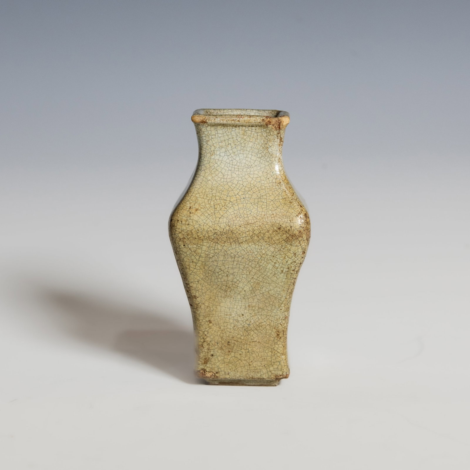 A Chinese Shiwan Crackle-Glazed Vase, Qing Dynasty: Chinese Shiwan Crackle-Glazed Vase, Qing dynasty. Of flattened pear-shaped form rising to a short waisted neck and everted rim, covered overall with an ivory-toned glaze suffused with an attractive