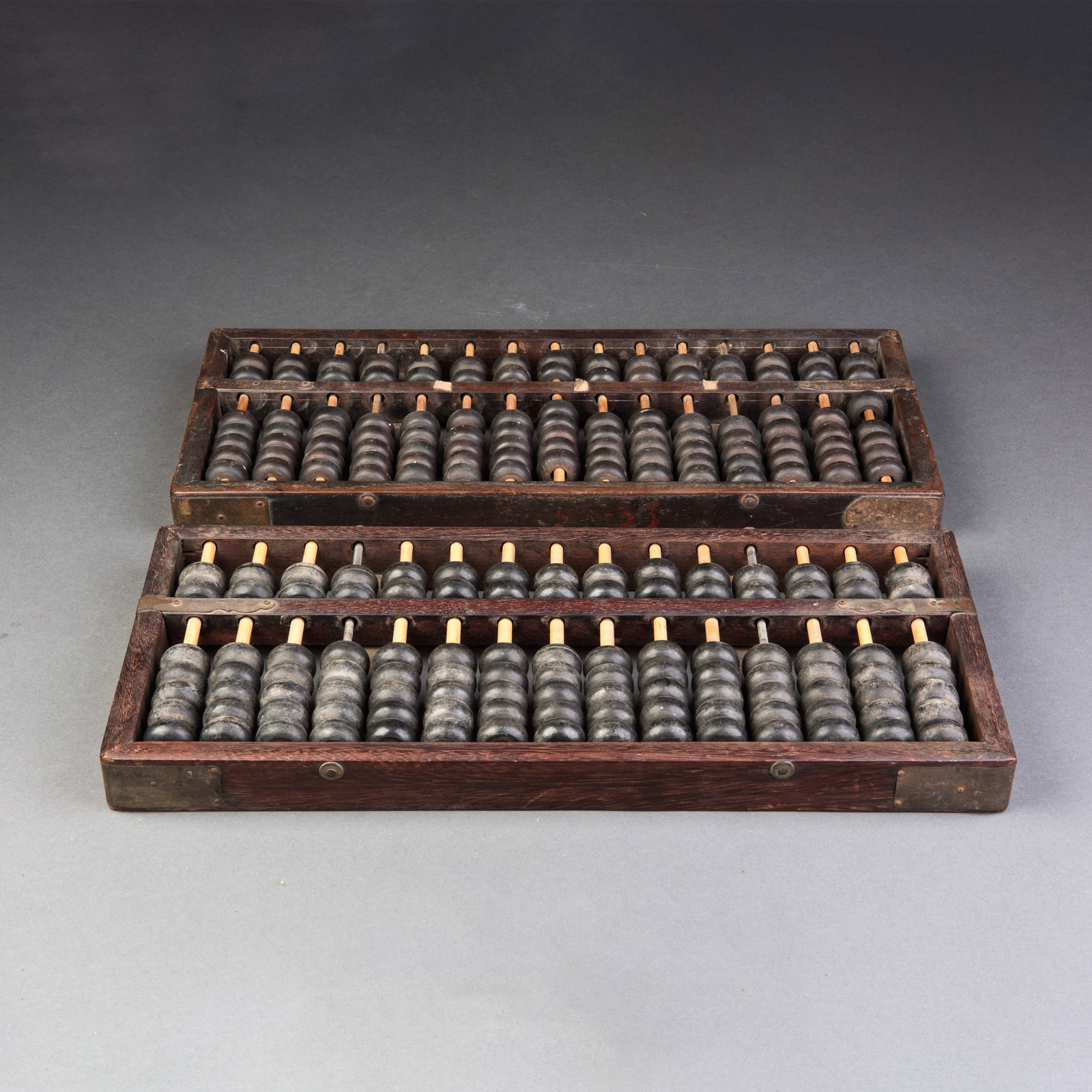 TWO VINTAGE HONGMU ABACUSES: (lot of 2) Two vintage Hongmu abacuses, composed of Hongmu frames and rods, with each rod housing a series of dark, rounded beads. Each consists of two sections: the upper deck with two beads per