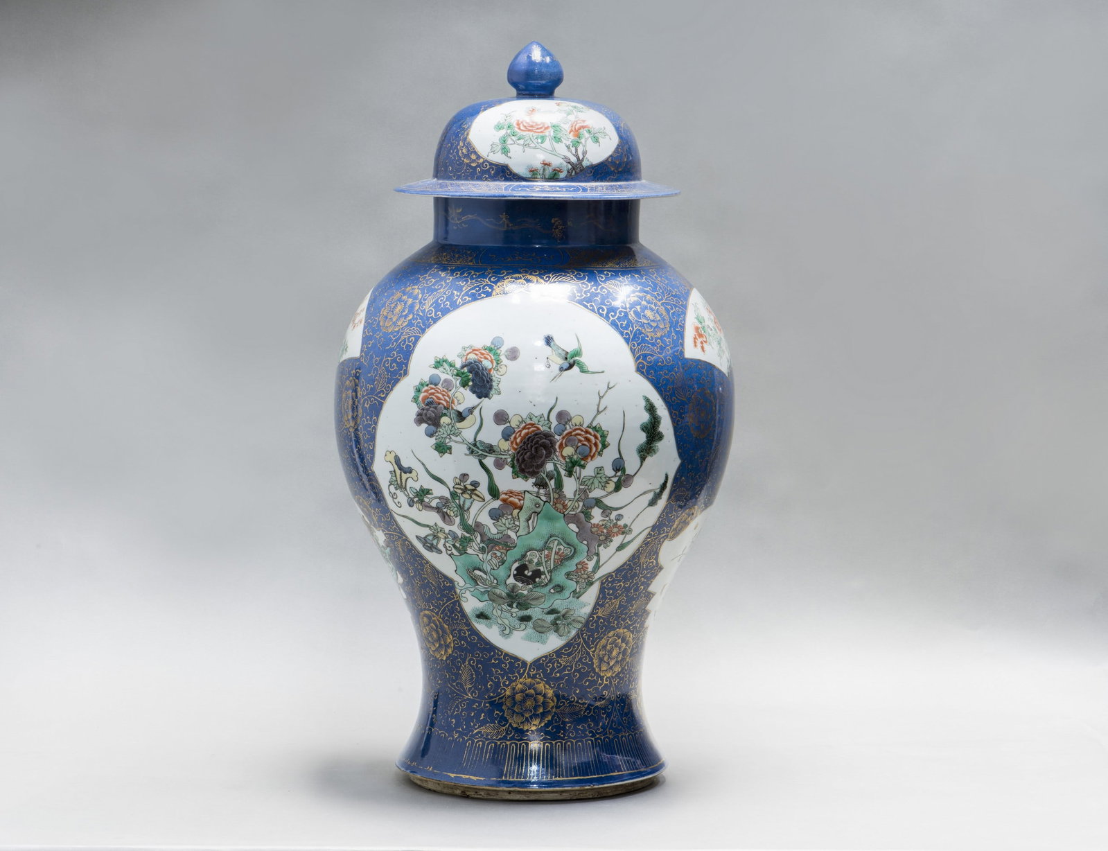 LARGE CHINESE FAMILLE ROSE POWDER-BLUE GROUND BALUSTER VASE AND COVER, 19TH CENTURY: A Chinese Famille rose powder-blue ground baluster vase and cover, 19th century. Featuring impressive powder blue, Famille rose, and gilt embellishments. The baluster bodies showcase grand leaf and fa