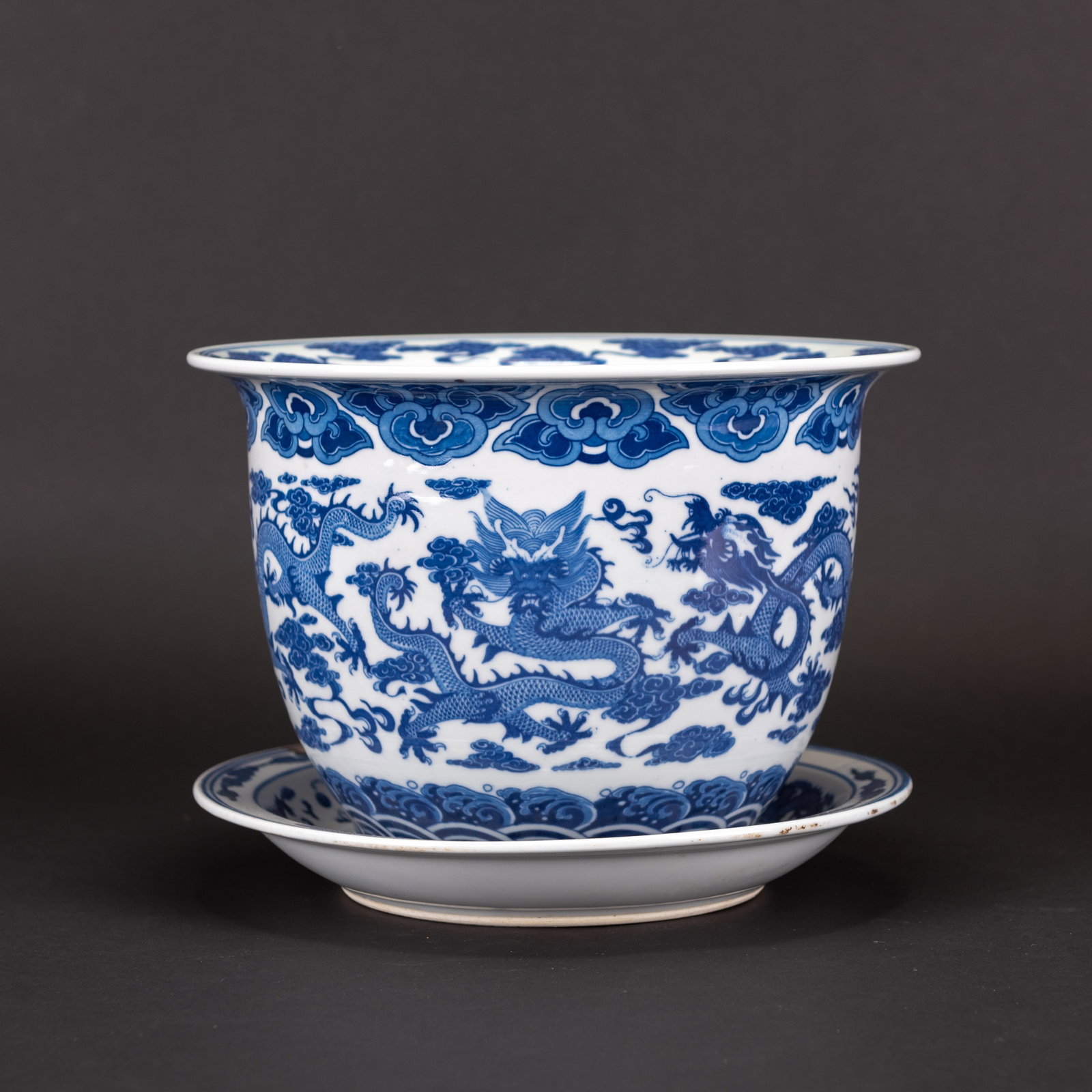 A CHINESE 'DRAGON' BLUE AND WHITE FLOWER POT WITH UNDERCARRIAGE PLATE: A Chinese 'dragon' blue and white flower pot with 'Jing De Zhen Zhi' mark at bottom, including matching undercarriage plate. Jardiniere: 7.48"h x 10.63"d (19 x 27 cm); Plate: 1.57"h x 10.63"d (4 x 27 