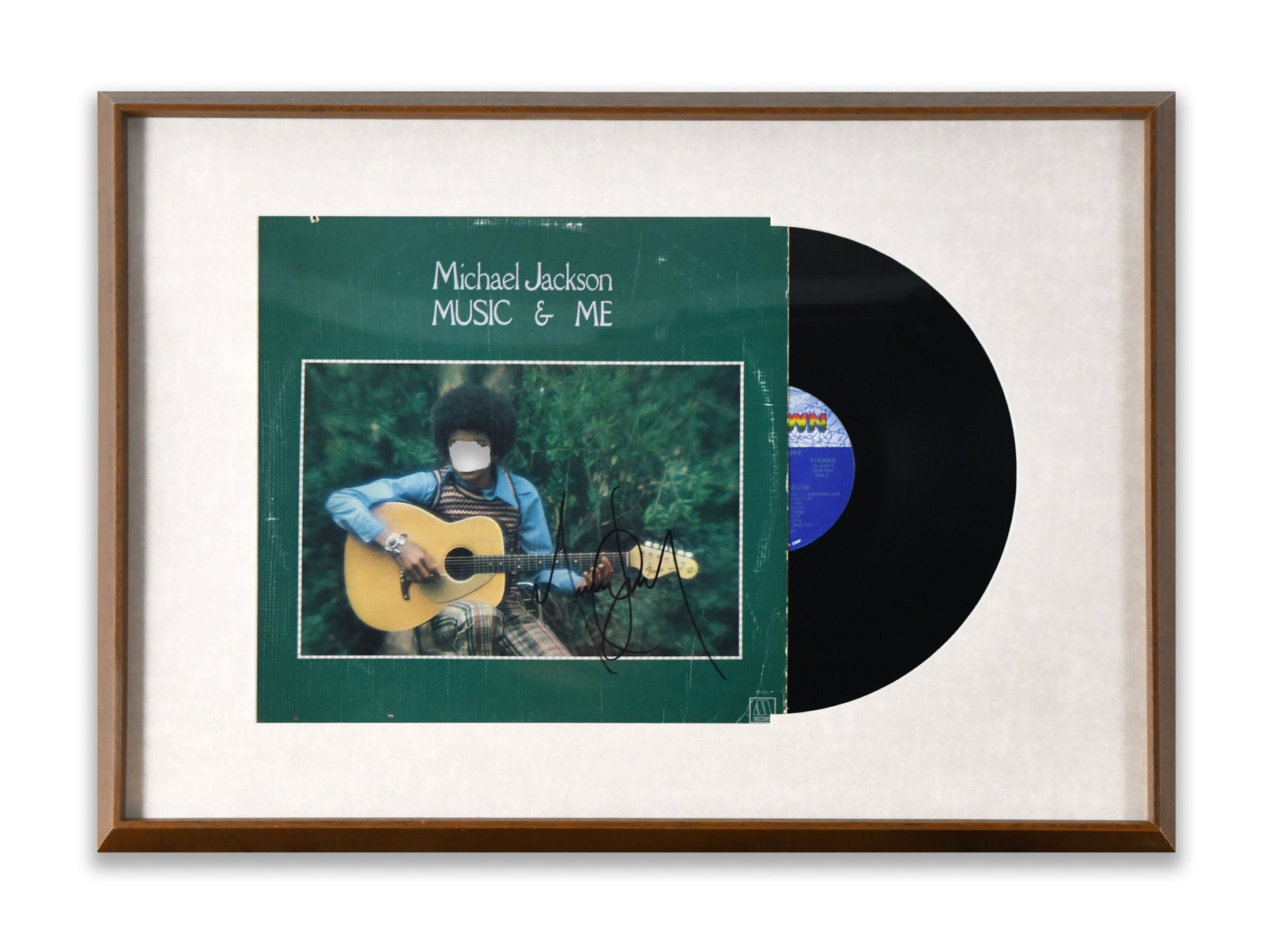 MICHAEL JACKSON FRAMED ALBUM DISPLAY "MUSIC & ME", BEARING SIGNATURE: A framed album display for "Music & Me". The display bears an ink mark.