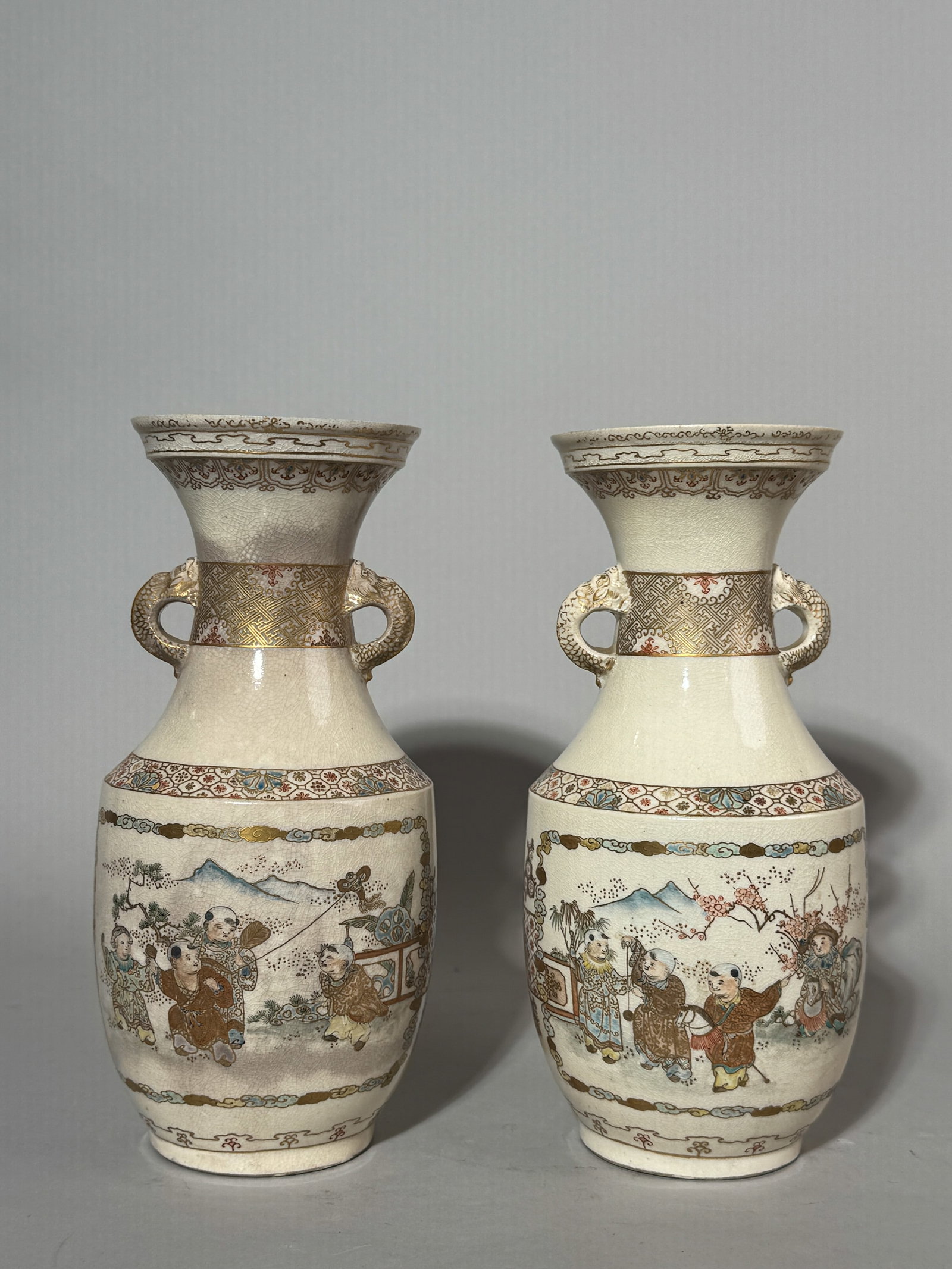 PAIR OF JAPANESE SATSUMA VASES WITH BOY SCENE: A pair of Japanese Satsuma vases with a boy scene. Dimensions: Height: 9.5 in. (24.1 cm). Note: This item is in New York, where it can be shipped from.