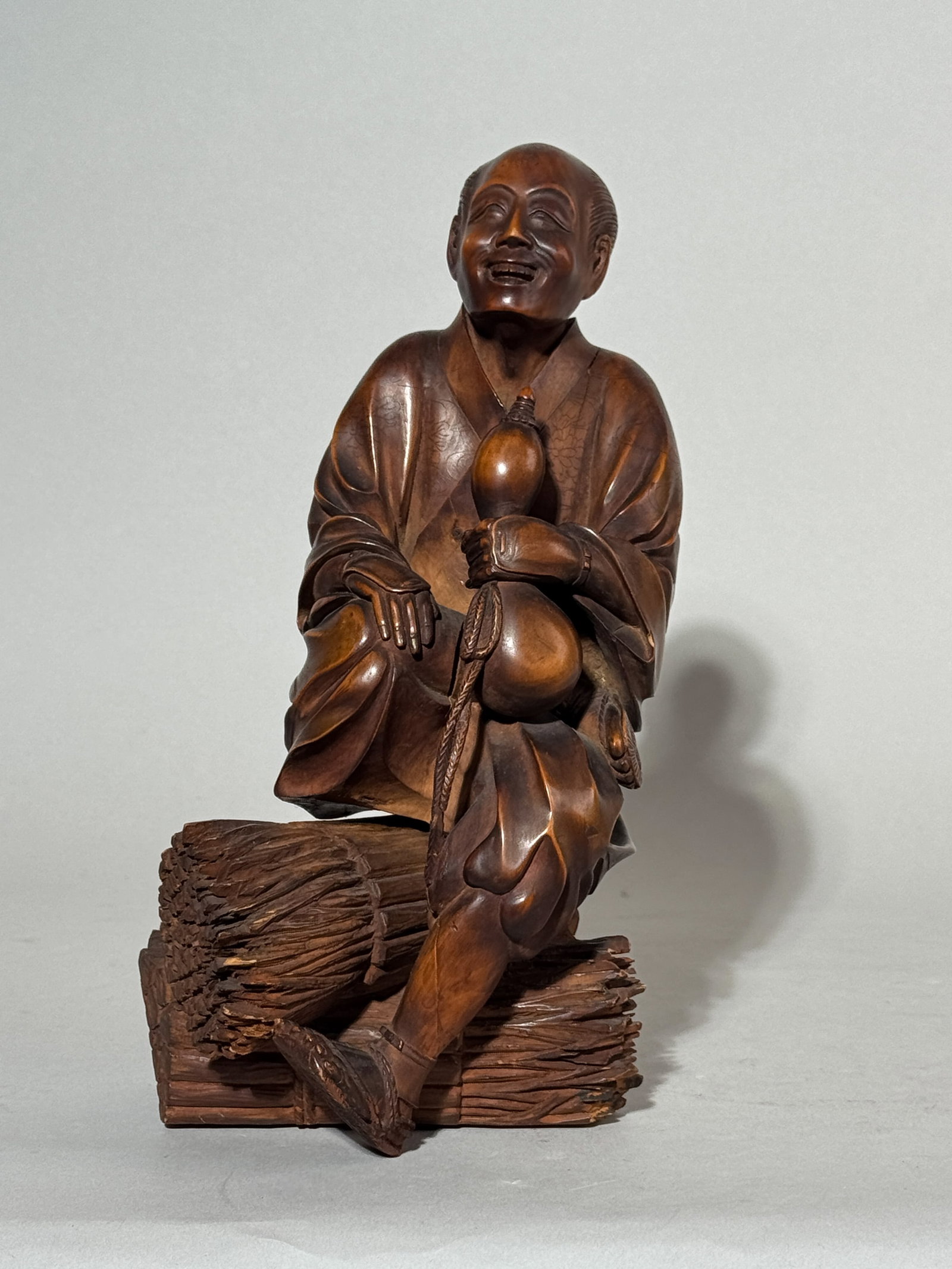 JAPANESE BOXWOOD CARVING OF A RESTING SAMURAI: A Japanese carved boxwood figurine of a resting samurai, unsigned. Wood split at the back. Dimensions: Height: 9.5 in. (24.1 cm). Note: This item is in New York, where it can be shipped from.