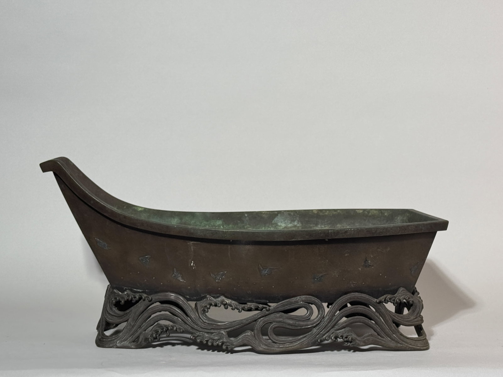 JAPANESE MIXED METAL BOAT-SHAPED IKEBANA: A Japanese mixed metal bronze boat-shaped vessel for Ikebana, with a silver-inlaid birds motif. Dimensions: Length: 18 in. (45.7 cm); Height: 9 in. (22.9 cm). Note: This item is in New York, where it 