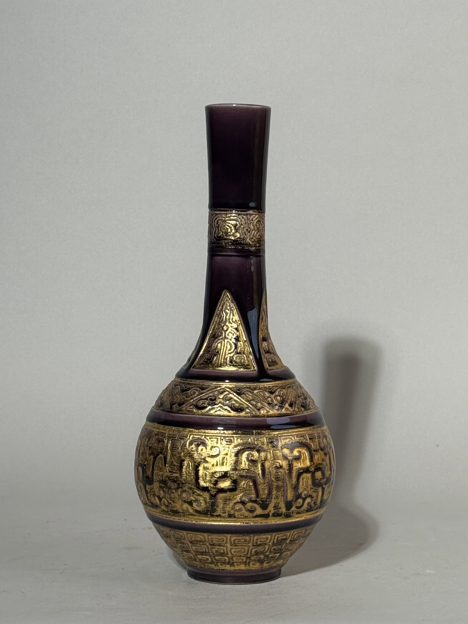 JAPANESE PURPLE STUDIO PORCELAIN VASE WITH GILT: A Japanese purple studio porcelain vase with a gilt stylized dragon motif. Dimensions: Height: 10 in. (25.4 cm). Note: This item is in New York, where it can be shipped from.