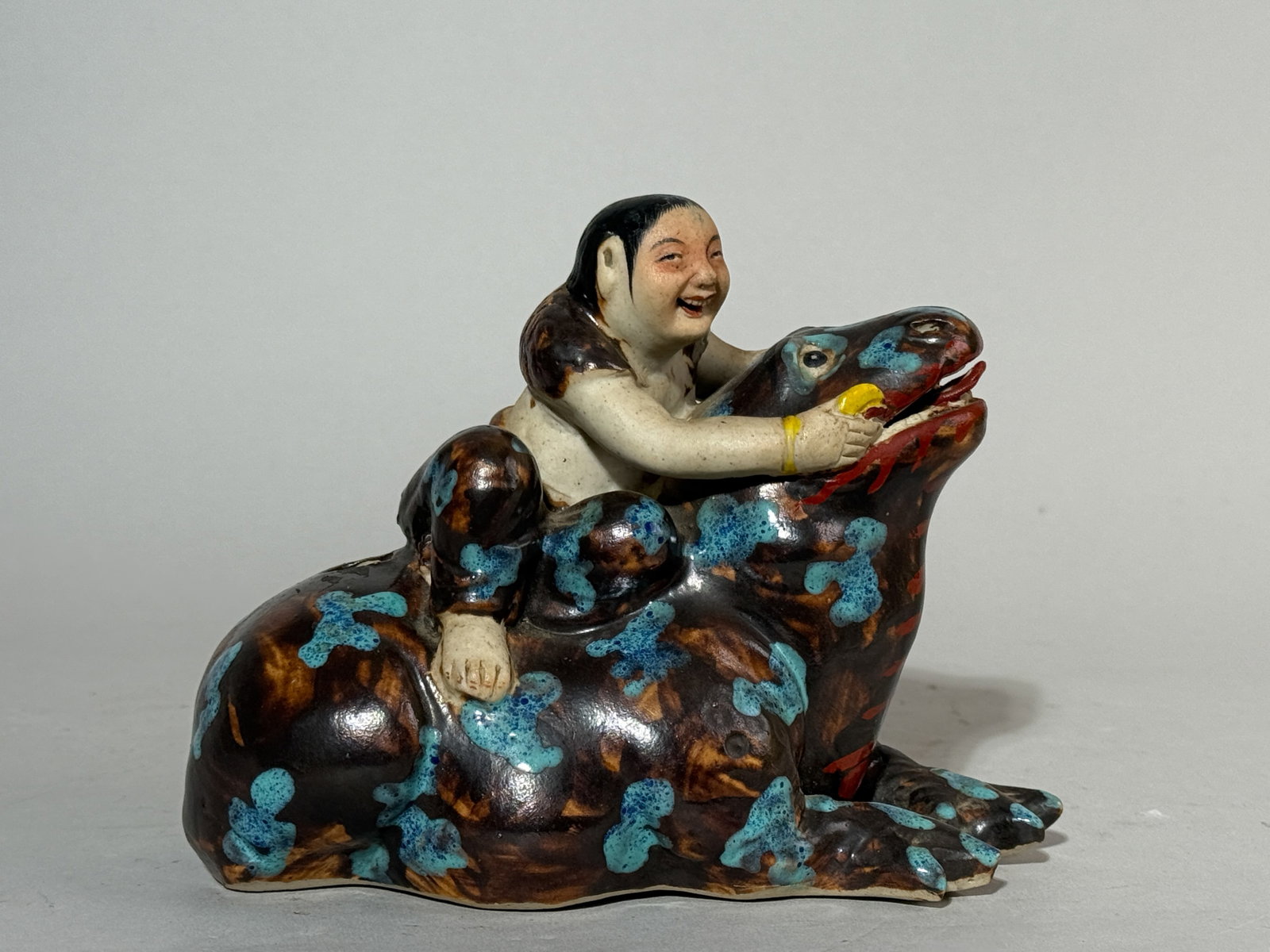 CHINESE PORCELAIN LIU HAI ON TOAD: A Chinese porcelain Liu Hai on a toad. Dimensions: Length: 6.5 in. (16.5 cm). Note: This item is in New York, where it can be shipped from.
