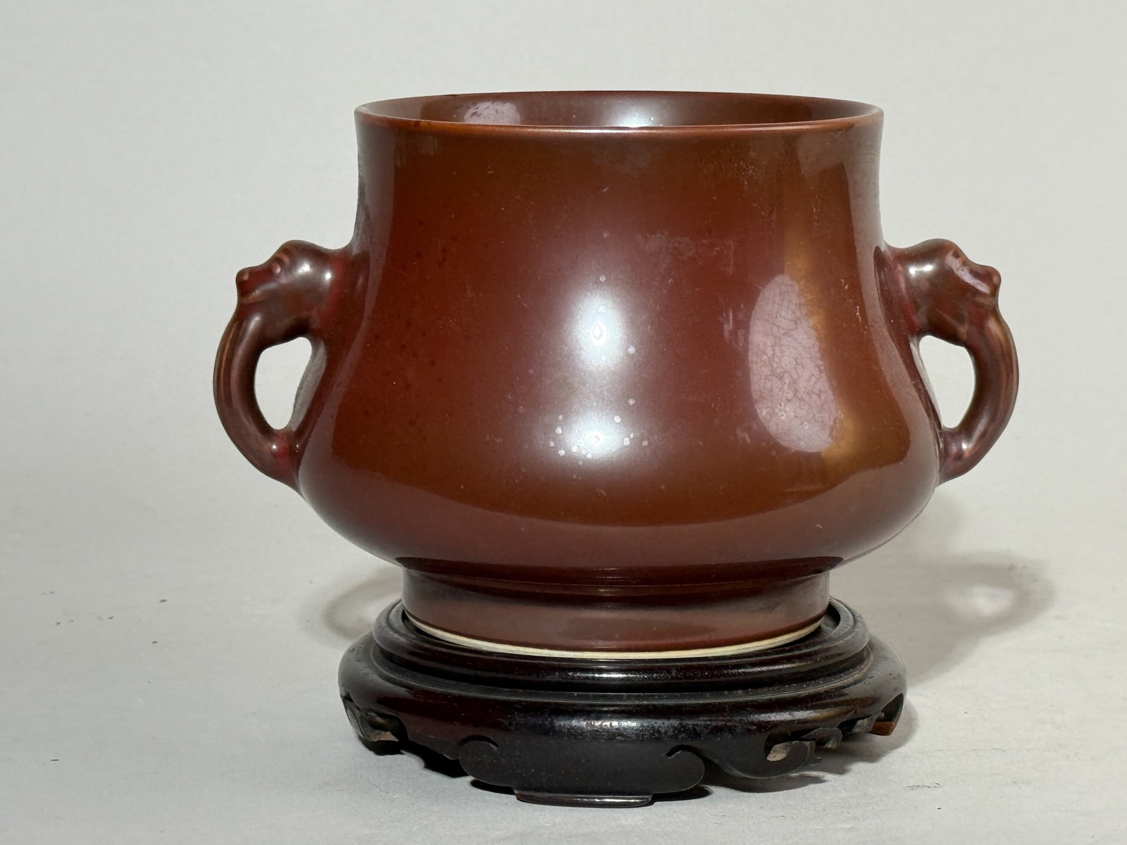 CHINESE PORCELAIN CENSER ON HARDWOOD BASE: A Chinese monochrome porcelain censer on a hardwood base. Dimensions: Width: 7 in. (17.8 cm); Height: 4 in. (10.2 cm). Note: This item is in New York, where it can be shipped from.