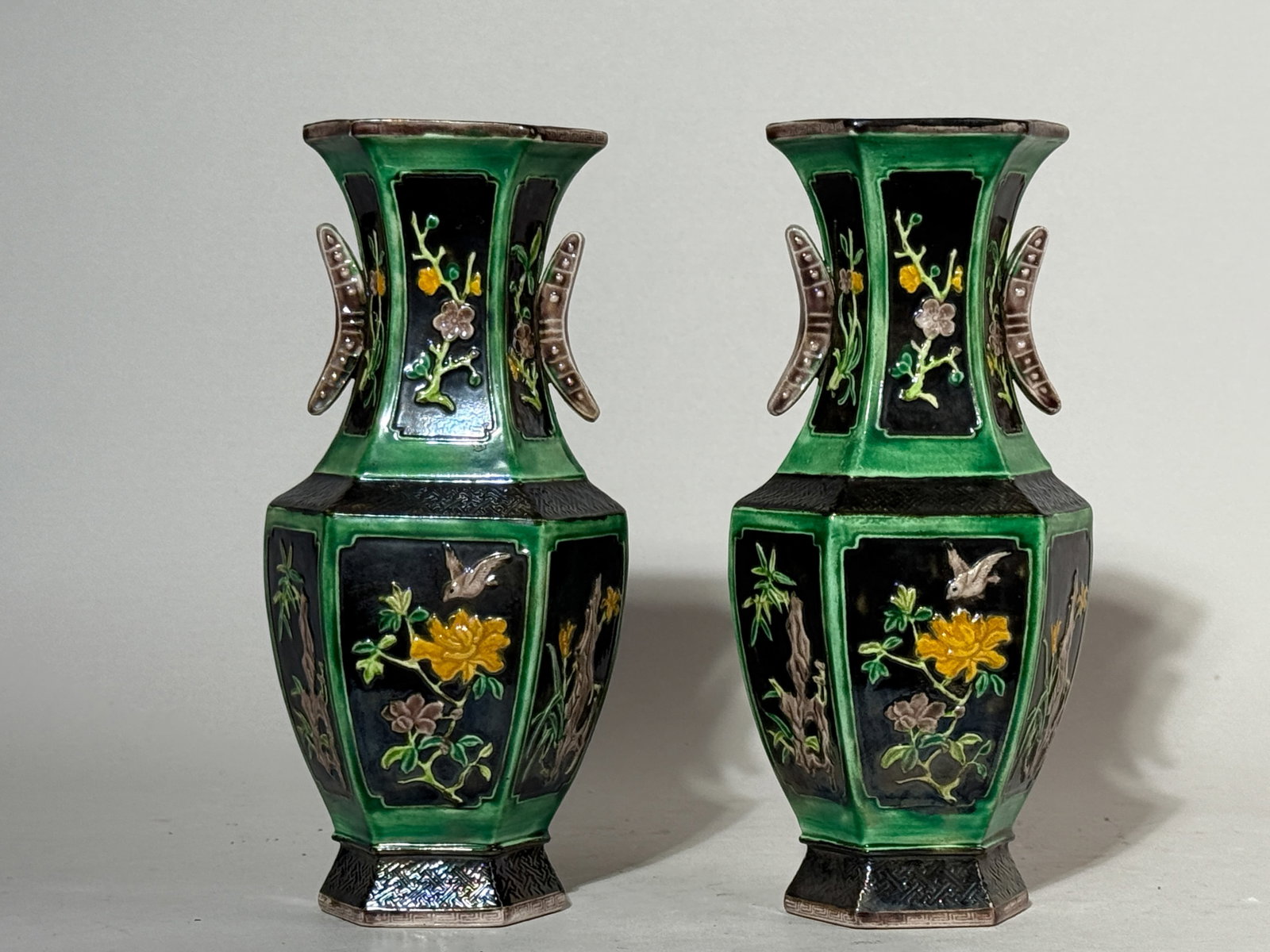 PAIR OF CHINESE SANCAI PORCELAIN HEXAGONAL VASES: A pair of Chinese Sancai porcelain hexagonal vases with a floral motif. Dimensions: Height: 8.25 in. (21 cm). Note: This item is in New York, where it can be shipped from.