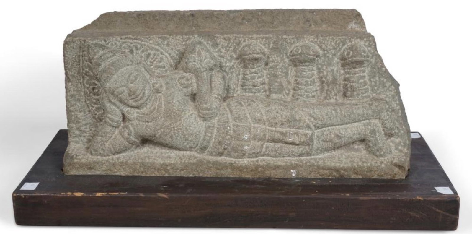 ANTIQUE CARVED KHMER STONE SCULPTURE ON WOOD STAND: An antique carved Khmer stone sculpture on a wood stand. Dimensions: Width: 16 in. (40.6 cm); Stone height: 8.25 in. (21 cm). Note: This item is in New York, where it can be shipped from.