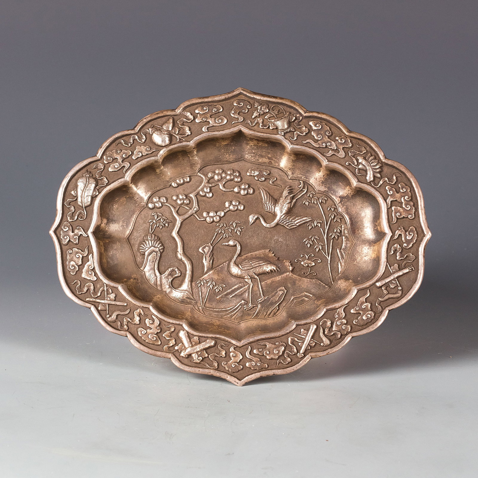 SILVER DISH: A silver dish exquisitely carved with patterns featuring cranes. Length: 8.5"; width: 6.75"; height: 0.5"