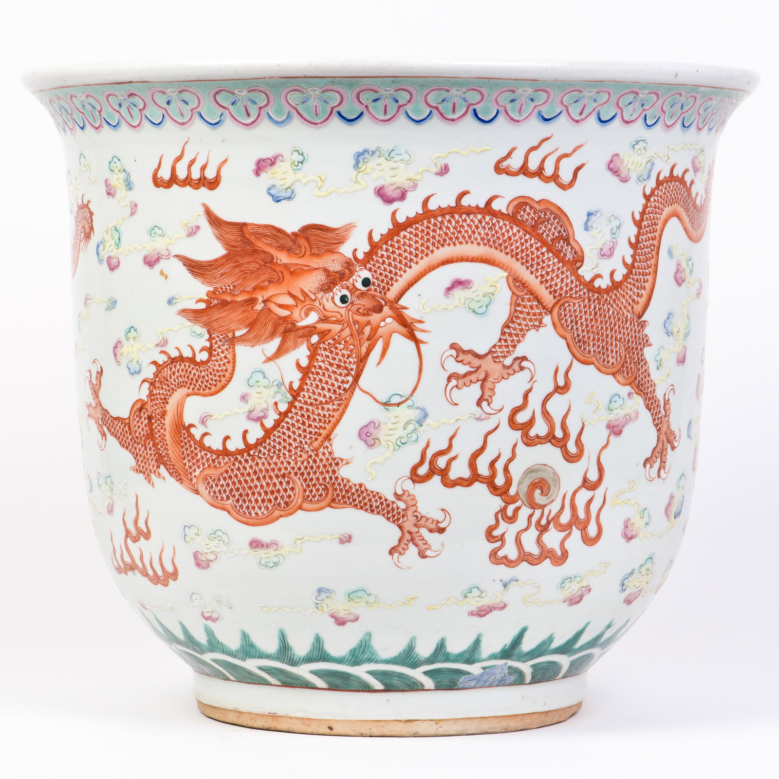A FAMILLE ROSE DRAGON POT, GUANGXU PERIOD: A famille rose dragon pot, sturdily potted and finely enameled on the exterior in iron-red glaze depicting a pair of ferocious dragons striding and chasing flaming pearls amidst flaming clouds and
