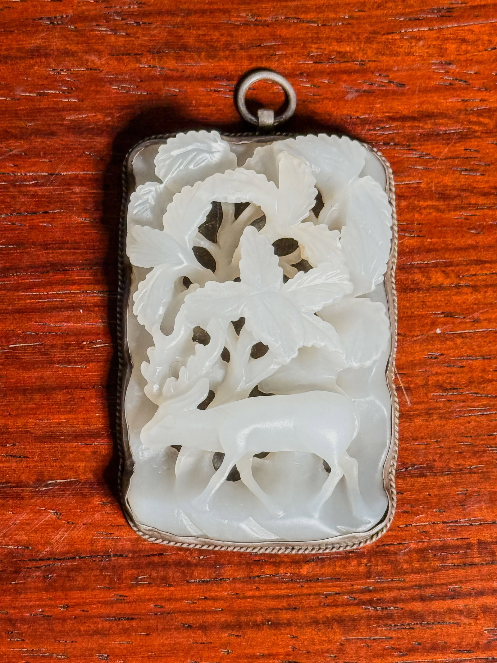 CHINESE WHITE JADE PLAQUE WITH DEER SCENE: A Chinese white jade plaque with a deer scene, mounted as a pendant. Dimensions: 1.5 x 2.5 in. (3.8 x 6.4 cm). Note: This item is in New York, where it can be shipped from.