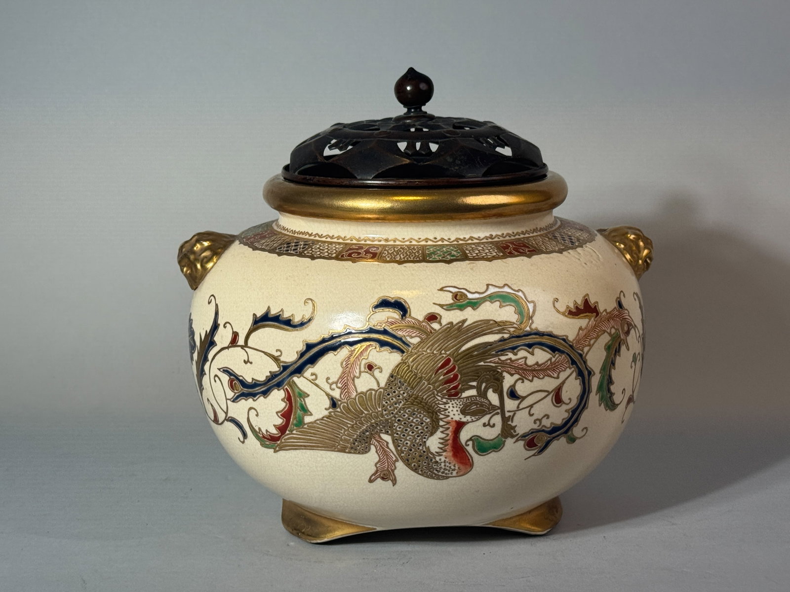 JAPANESE GOSU BLUE SATSUMA CENSER WITH LION-MASK HANDLE: Nice Japanese Meiji-period Satsuma censer with gosu blue enamel, fitted copper cover, signature at bottom, and an old Japanese collector paper label. Dimensions: Width: 9 in. (22.9 cm); Height: 7.5 in