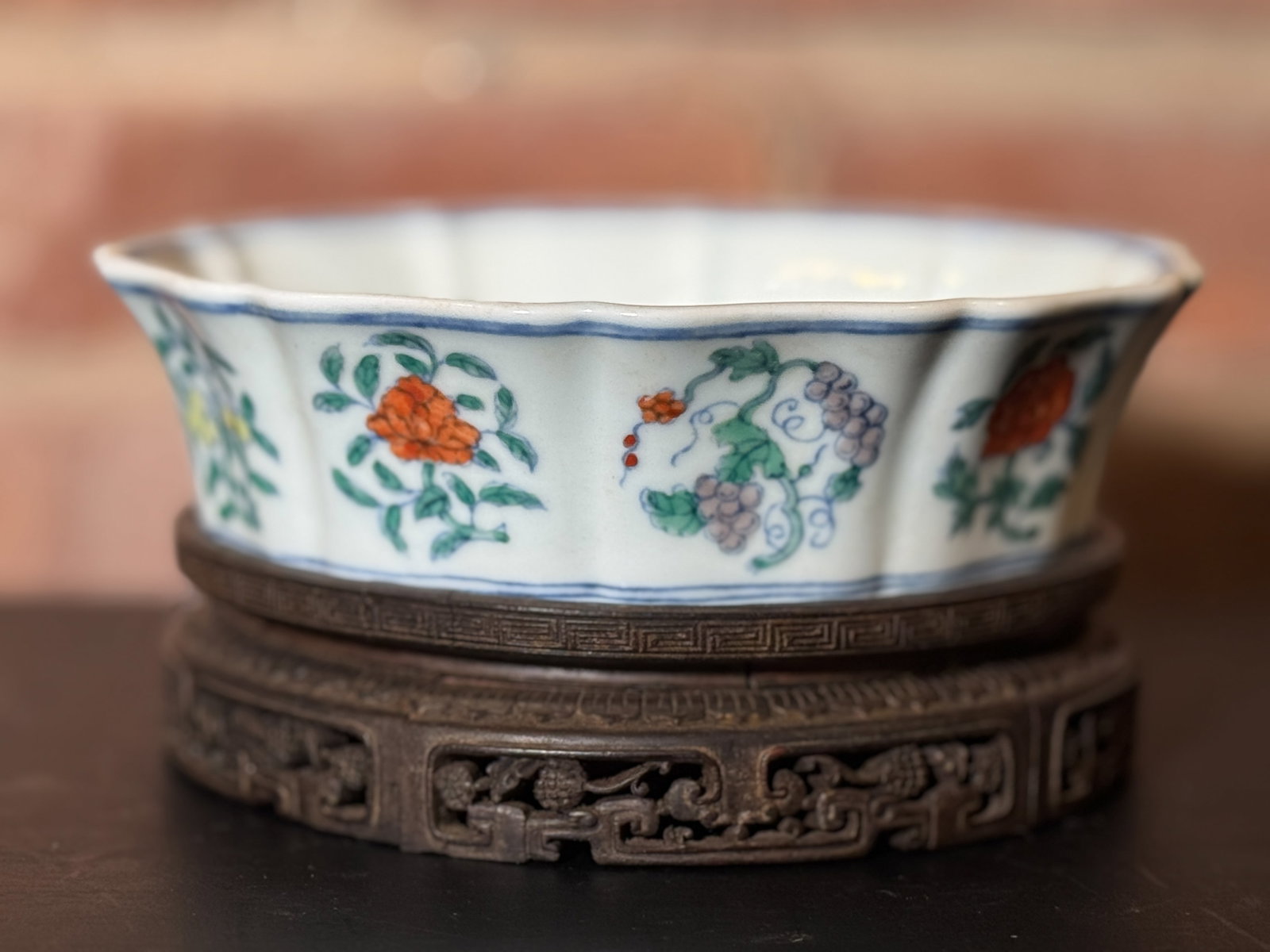 CHINESE DOUCAI LOBED BRUSH WASHER ON ZITAN BASE: Chinese doucai lobed brush washer on a zitan wood base. The wood has splits and losses. Dimensions: Porcelain Diameter: 7 in. (17.8 cm); Porcelain Height: 2 in. (5.1 cm). Note: This item is in New Yor