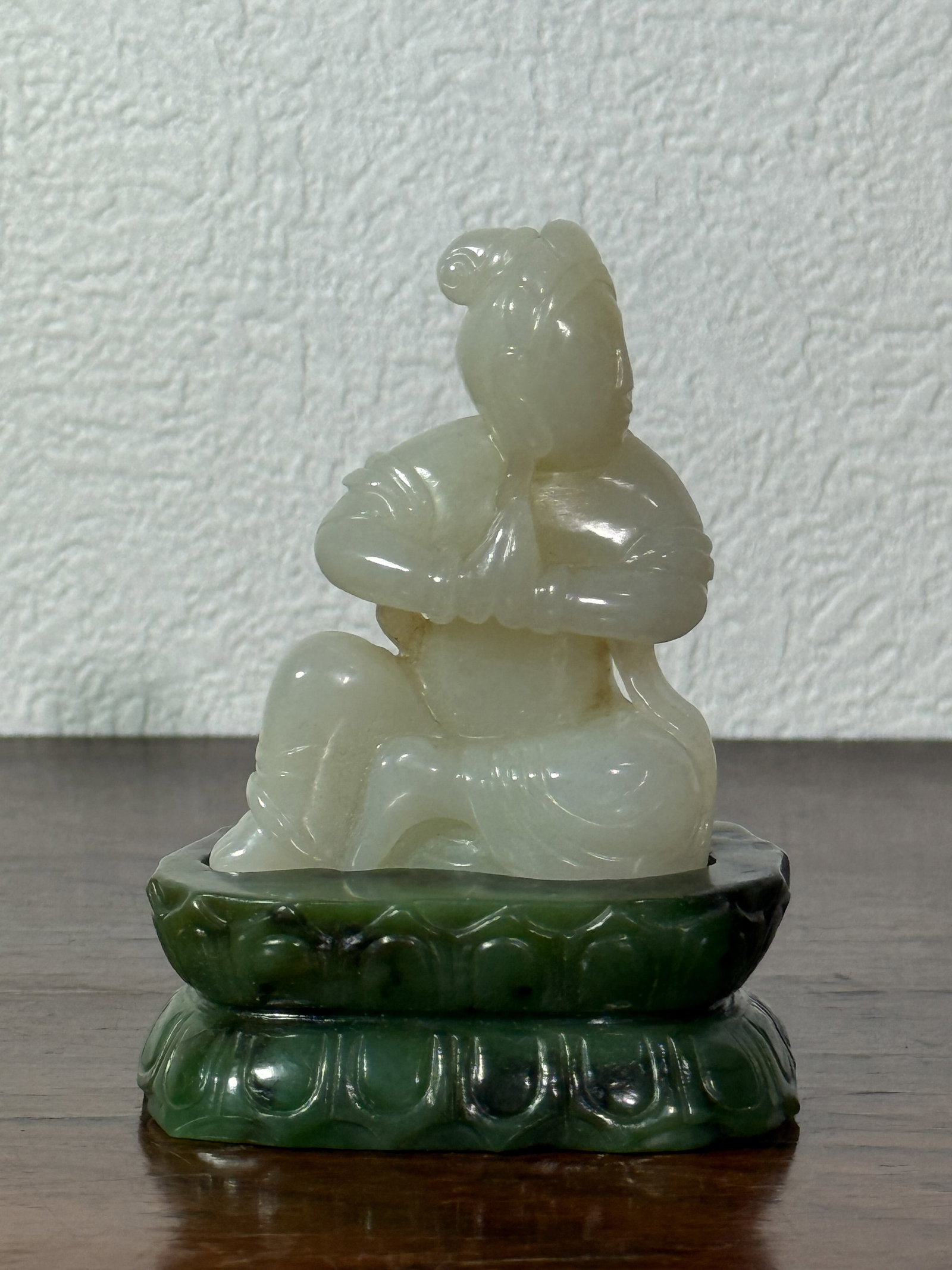 CHINESE WHITE JADE KUANYIN ON SPINACH JADE BASE: Chinese white jade Kuanyin with fitted spinach jade base. Dimensions: Height: 4 in. (10.2 cm). Note: This item is in New York, where it can be shipped from.