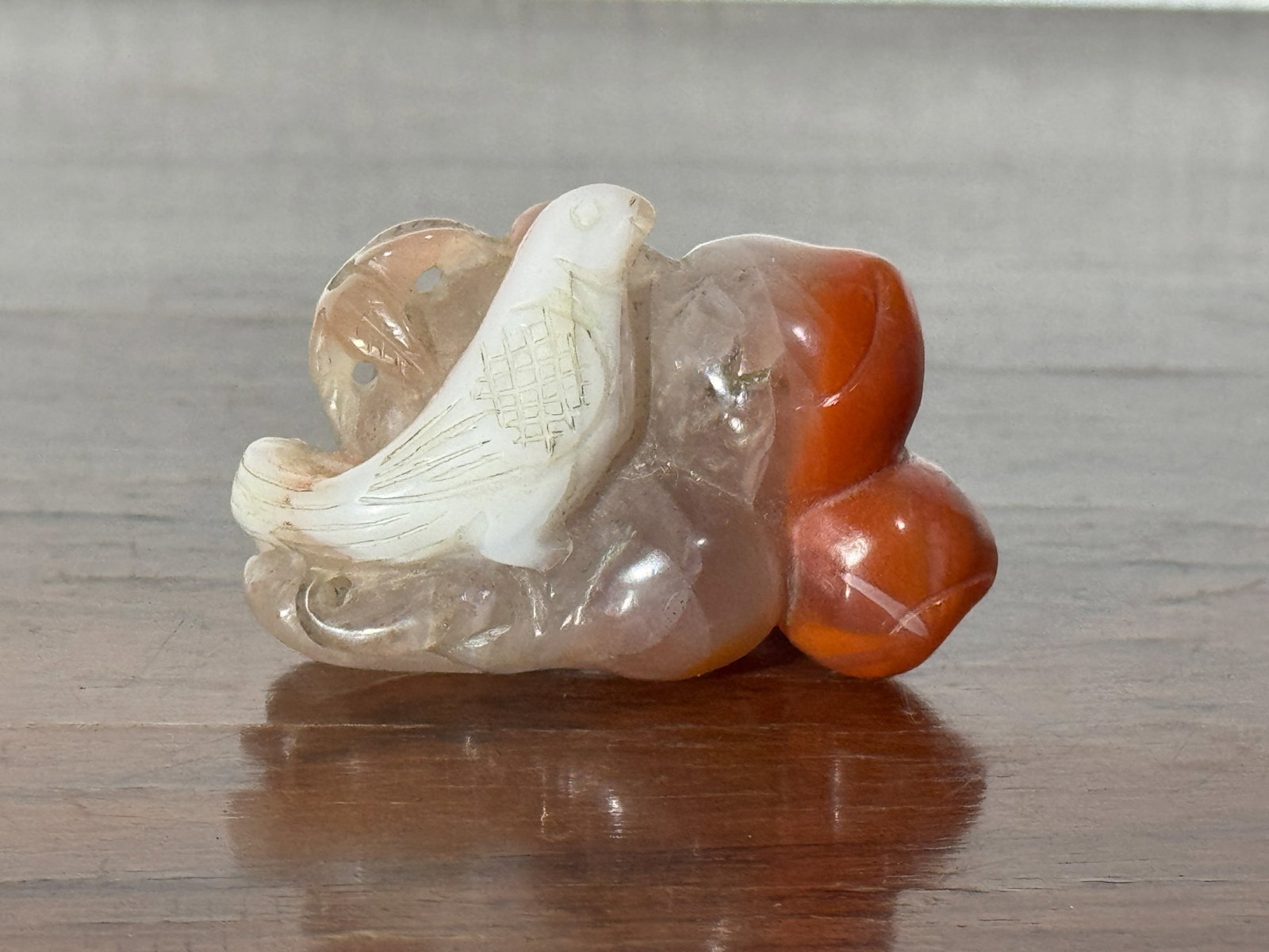 CHINESE AGATE PENDANT WITH BIRD MOTIF: Chinese Nanhong agate pendant with bird motif. Dimensions: Length: 2 in. (5.1 cm). Note: This item is in New York, where it can be shipped from.