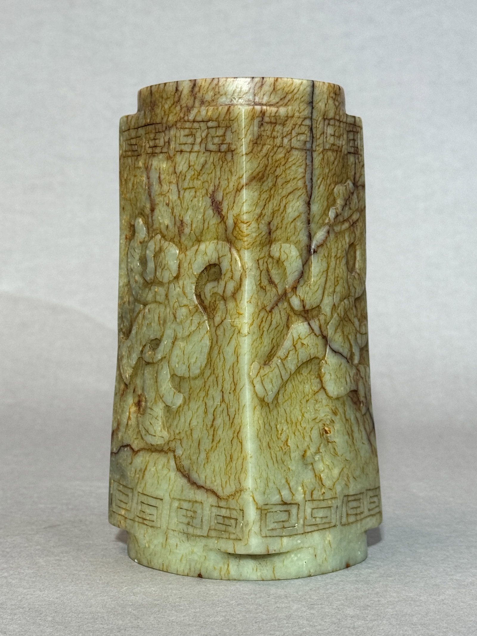 CHINESE ARCHAIC JADE CONG: Chinese carved celadon jade cong with raised dancer motif. Dimensions: Height: 8 in. (20.3 cm). Note: This item is in New York, where it can be shipped from.