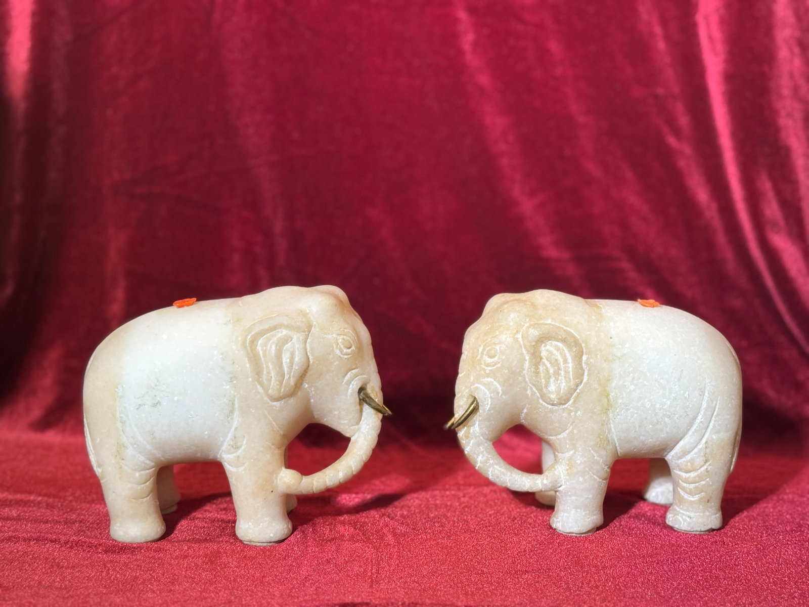 PAIR OF CHINESE WHITE MARBLE ELEPHANTS WITH BRONZE TUSKS: Pair of Chinese white marble elephants with bronze tusks. Dimensions: Length: 5.5 in. (14.0 cm); Height: 4.25 in. (10.8 cm). Note: This item is in New York, where it can be shipped from.