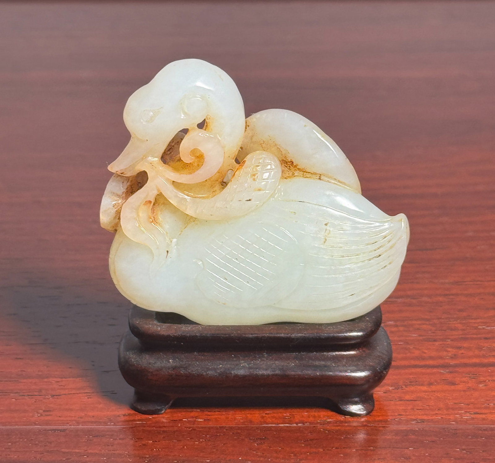 CHINESE CARVED JADE DUCK: Chinese white jade carving of a duck, on a rosewood stand. Dimensions: Height: 2 in. (5.1 cm); Length: 2.5 in. (6.3 cm). Note: This item is in New York, where it can be shipped from.