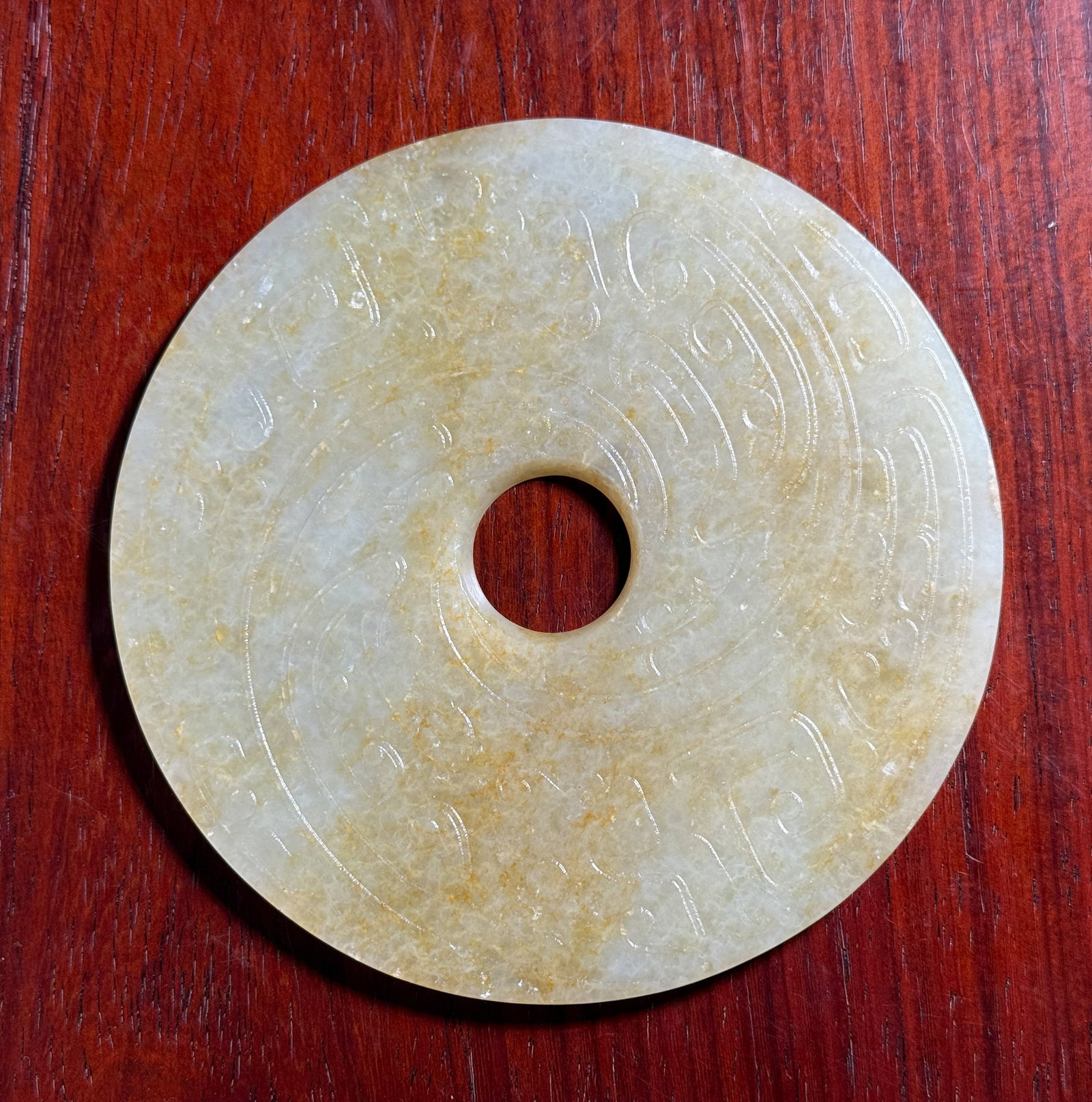 LARGE CHINESE CELADON JADE BI: Large Chinese celadon jade bi. Dimensions: Diameter: 5 in. (12.7 cm). Note: This item is in New York, where it can be shipped from.