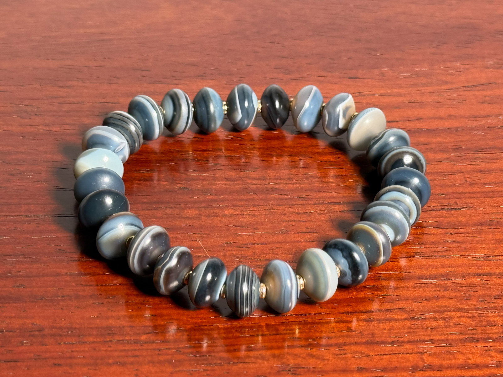 TIBETAN BANDED AGATE WRIST BAND: Tibetan banded agate wrist band. Dimensions: Circumference: 8 in. (20.3 cm). Note: This item is in New York, where it can be shipped from.