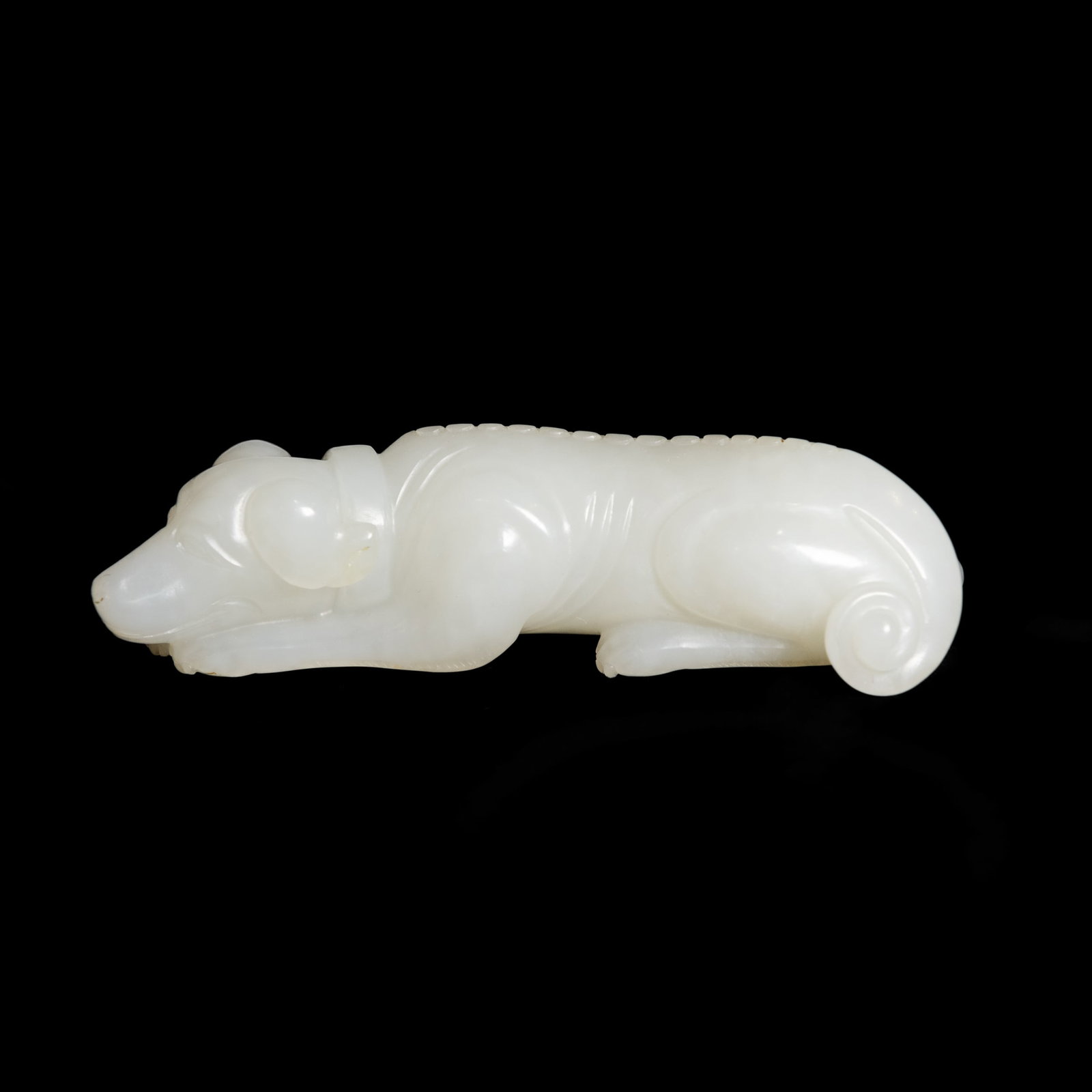 A CHINESE WHITE JADE ORNAMENT: A Chinese white jade ornament. 0.79"h x 3.66"w x 1.18"l (2 x 9.3 x 3 cm) Provenance: Property from a San Francisco private collection.